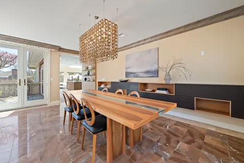 a living room with furniture a fireplace and a large window