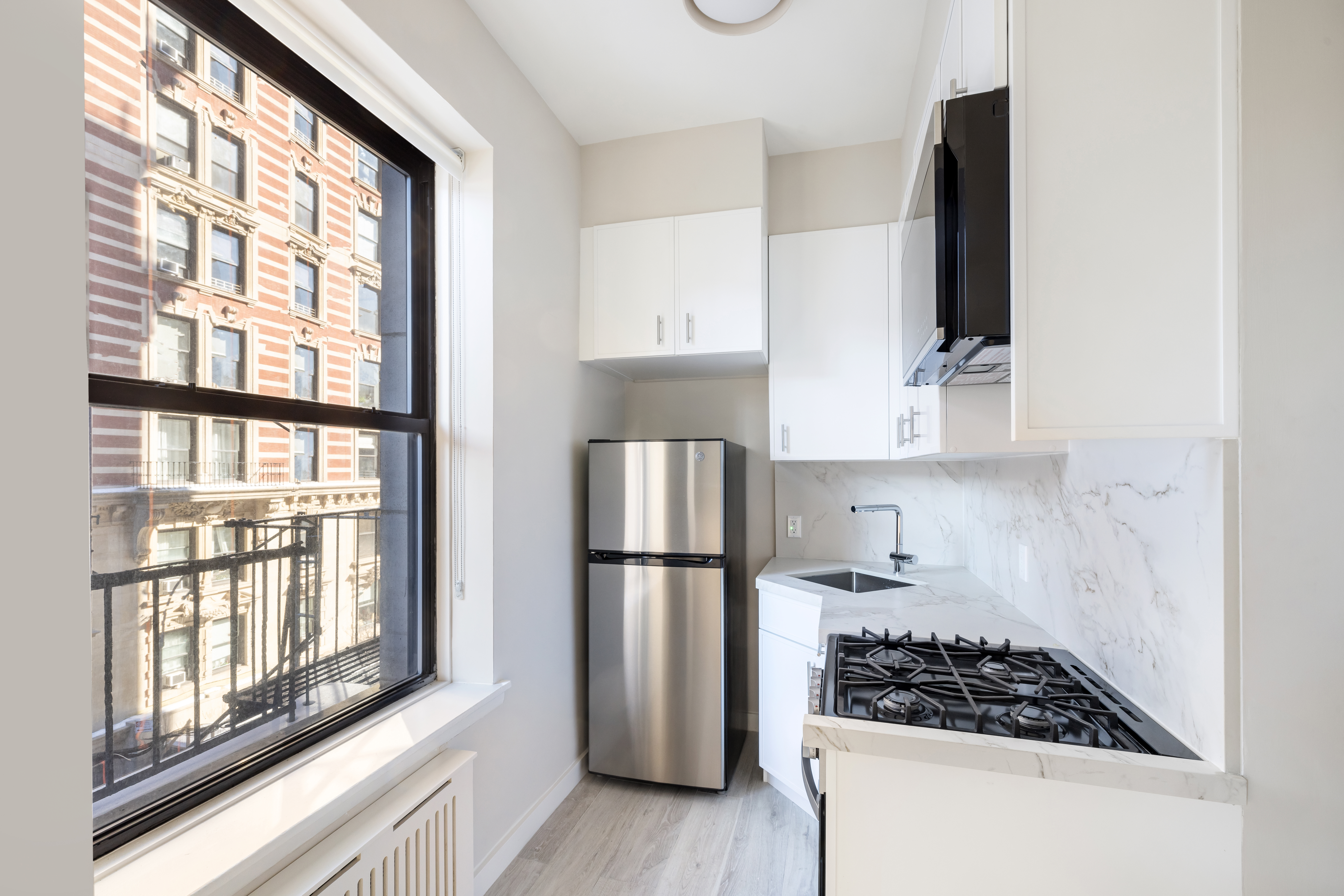102 West 80th Street, Unit 42 Manhattan, NY 10024 - Photo 4 of 6 a kitchen with stainless steel appliances granite countertop a refrigerator and a stove top oven