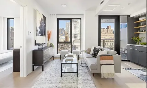 a living room with furniture and large window