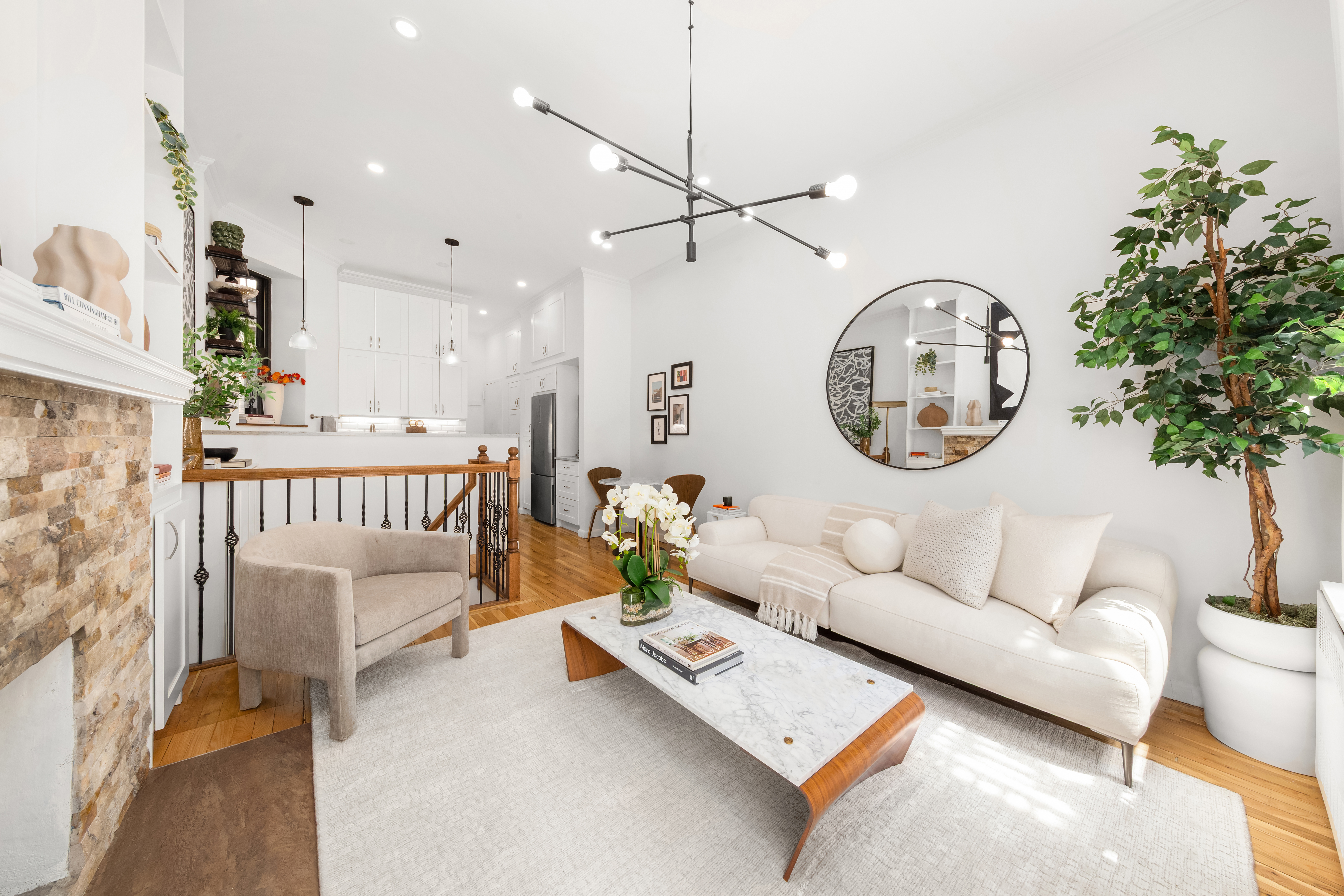 170 East 92nd Street, Unit 1D Manhattan, NY 10128 - Photo 2 of 12 a living room with furniture a clock and a chandelier