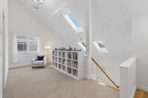 a living room with furniture and stairs