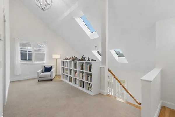 a living room with furniture and stairs