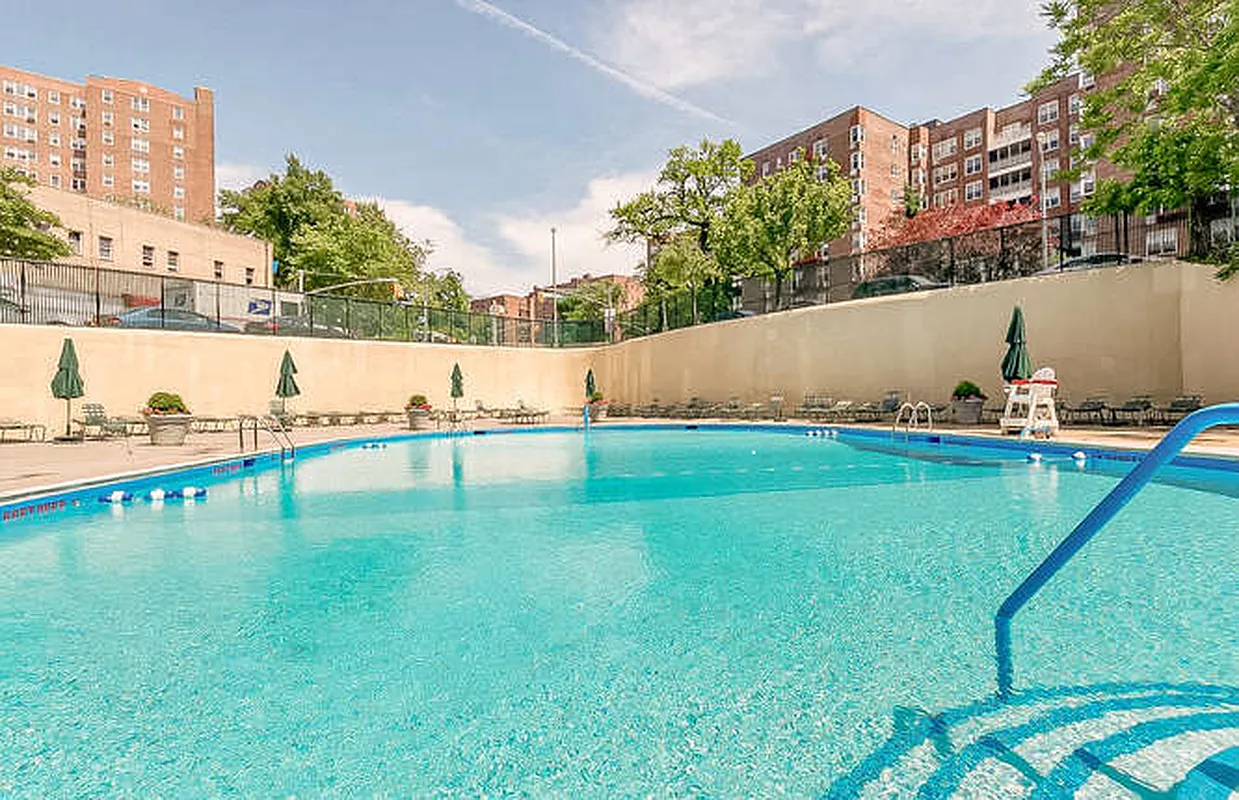 555 Kappock Street, Unit 11J Bronx, NY 10463 - Photo 19 of 24 a view of a lake with a yard and large trees