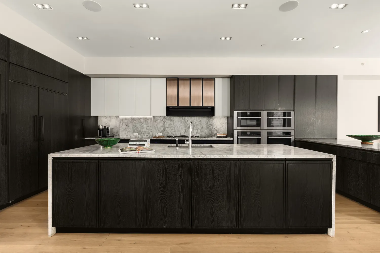 a kitchen with counter top space sink and refrigerator