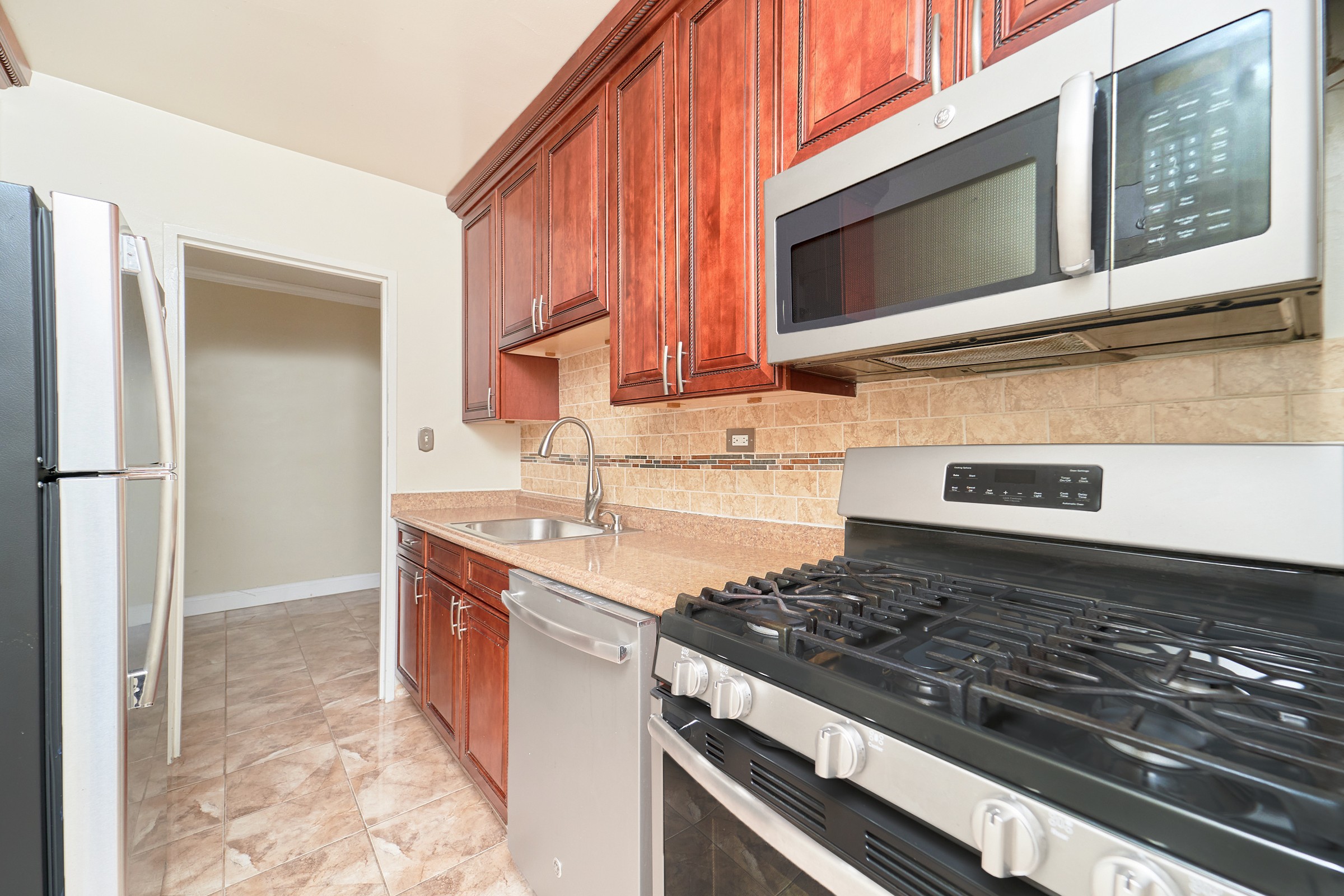 191 Willoughby Street, Unit 6N Brooklyn, NY 11201 - Photo 4 of 17 a kitchen with stainless steel appliances granite countertop a sink stove and refrigerator