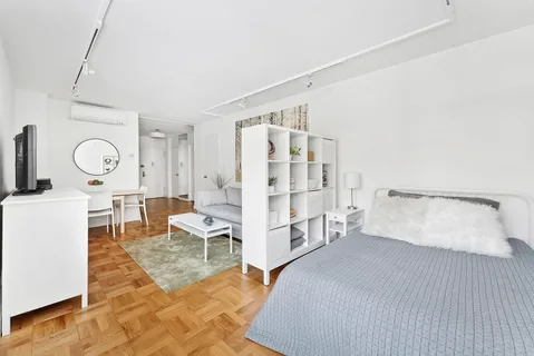 a bedroom with furniture and a large window