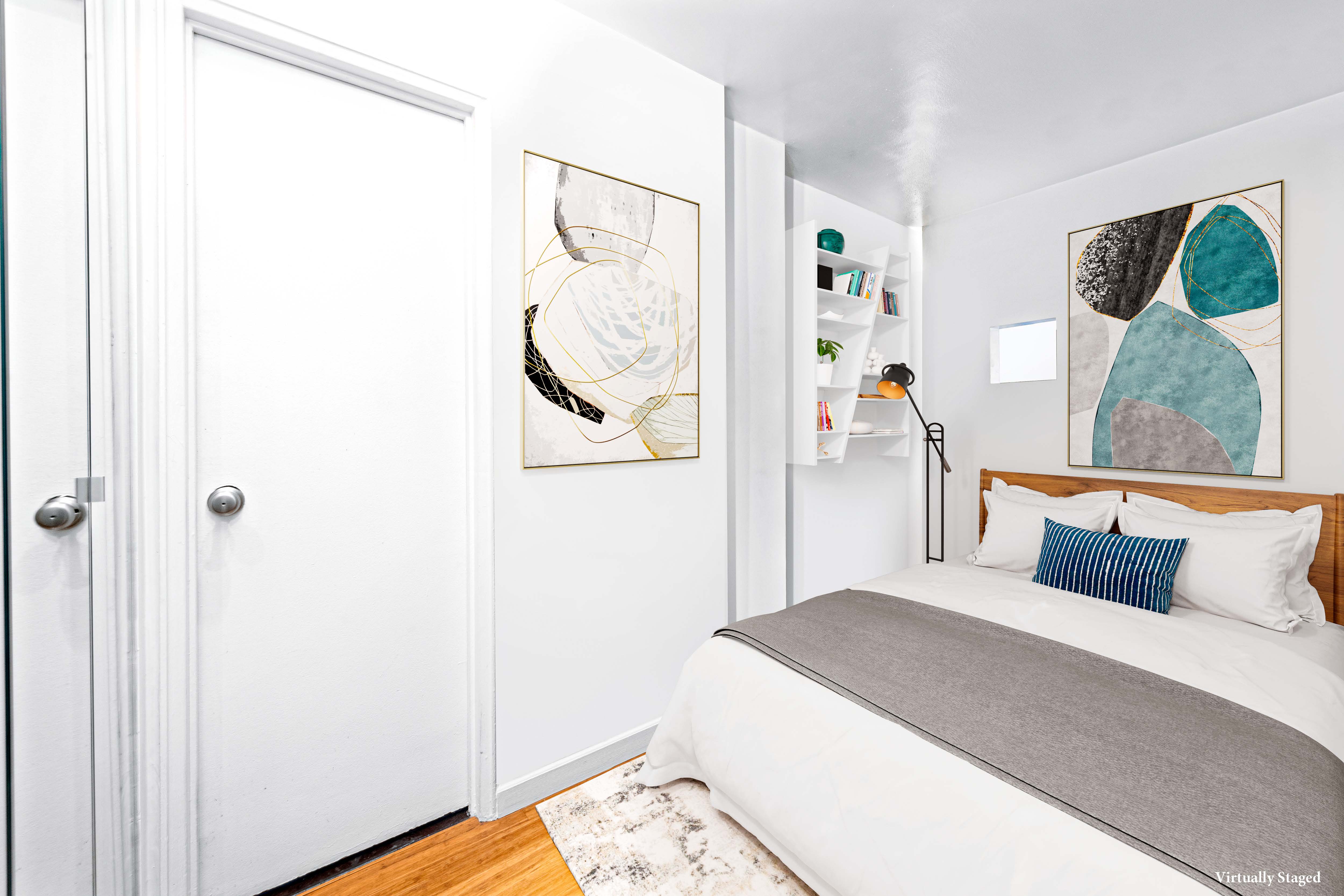 69 West 9th Street, Unit 9H Manhattan, NY 10011 - Photo 2 of 6 a bedroom with a bed and a painting on the wall