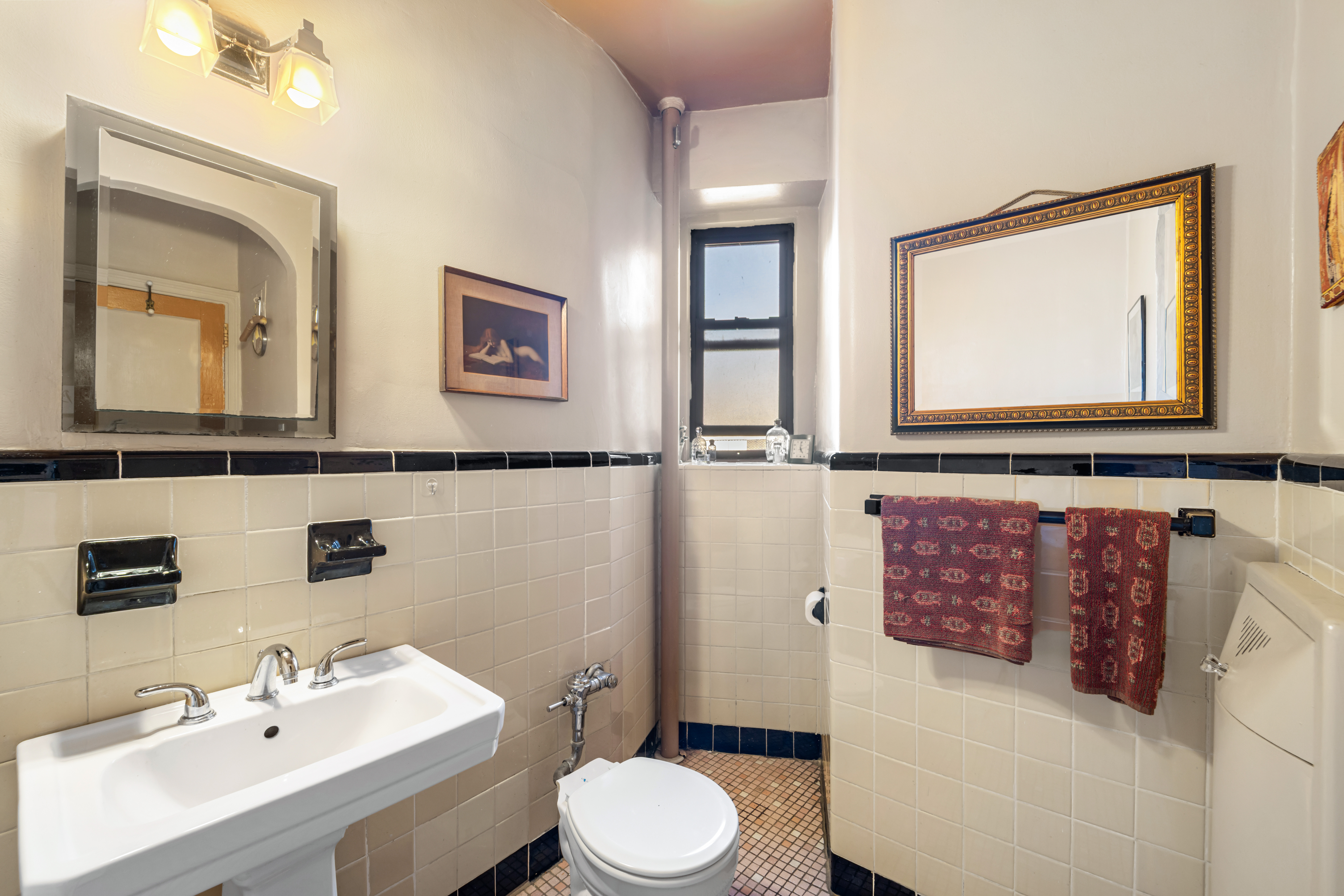 34-24 82nd Street, Unit 6N Queens, NY 11372 - Photo 7 of 15 a bathroom with a sink mirror and toilet