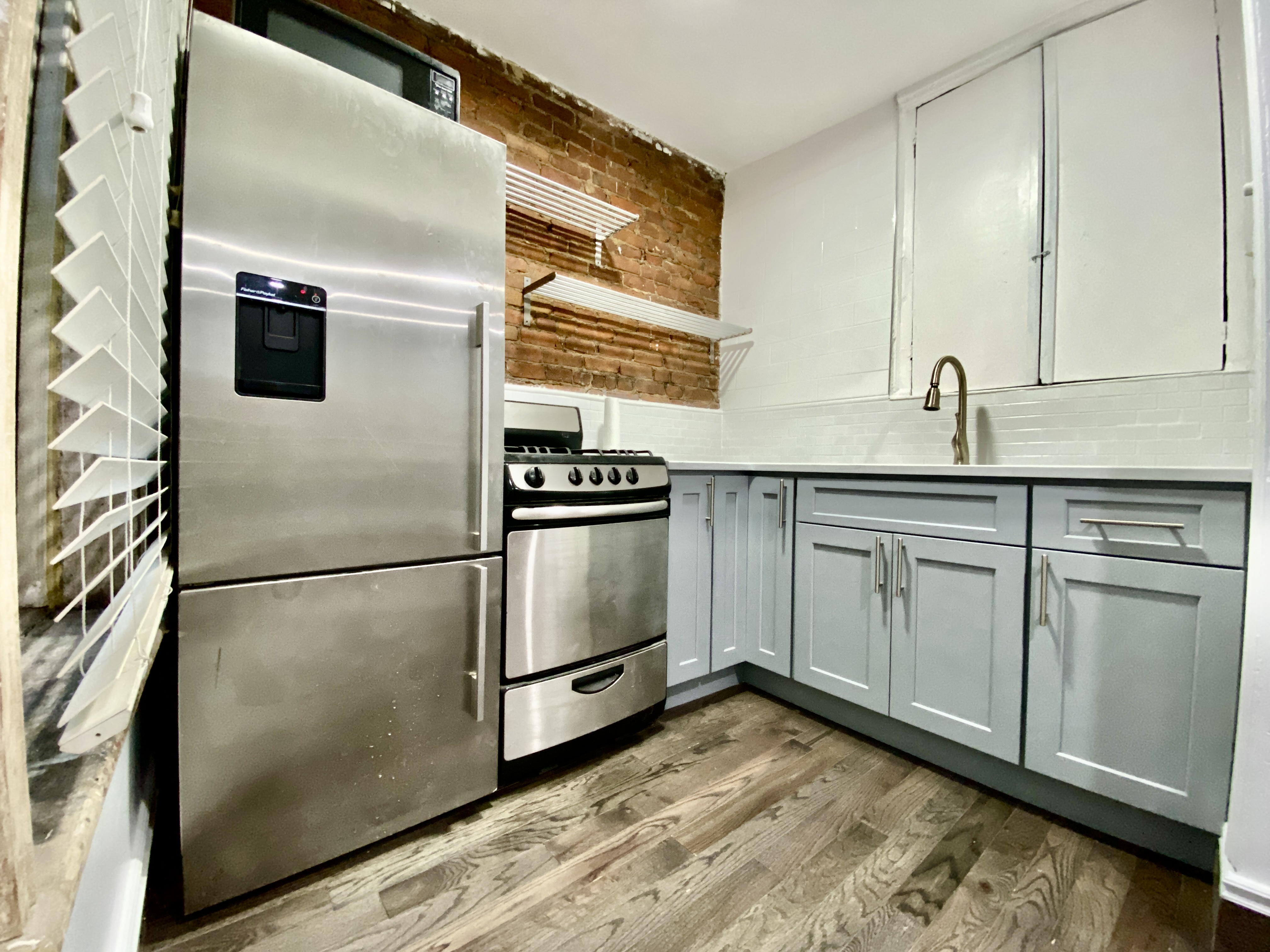 398 Decatur Street, Unit 3 Brooklyn, NY 11233 - Photo 4 of 9 a kitchen with white cabinets and white appliances