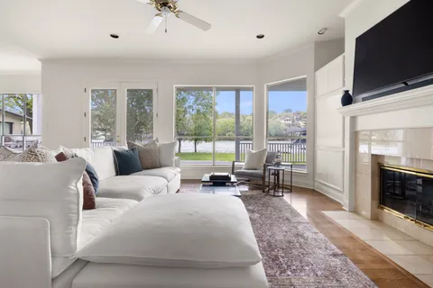 a living room with furniture a flat screen tv and a fireplace