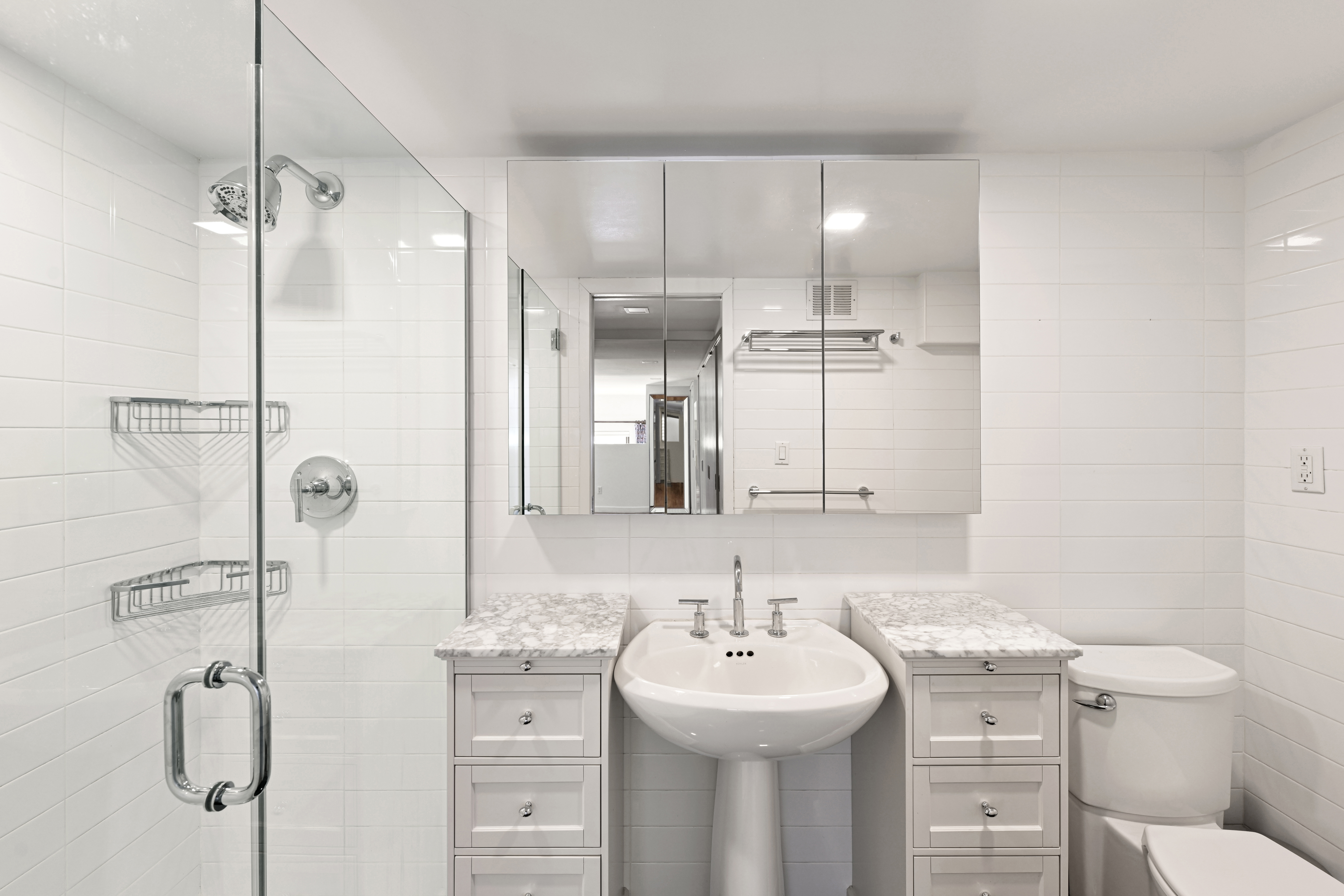 305 2nd Avenue, Unit 325 Manhattan, NY 10003 - Photo 7 of 22 a bathroom with a sink toilet and shower