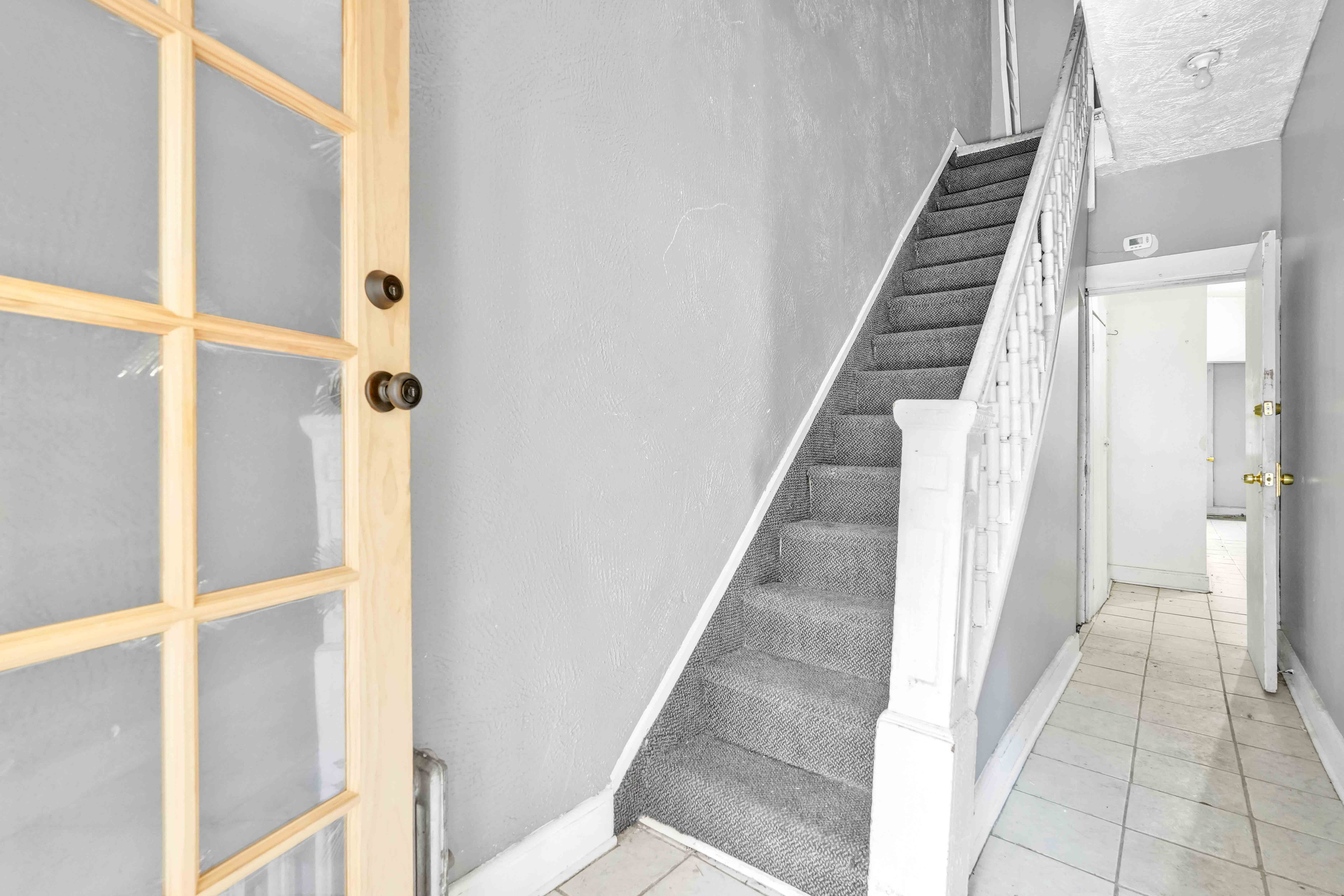 610 Ashford Street Brooklyn, NY 11207 - Photo 12 of 28 a view of a hallway with staircase