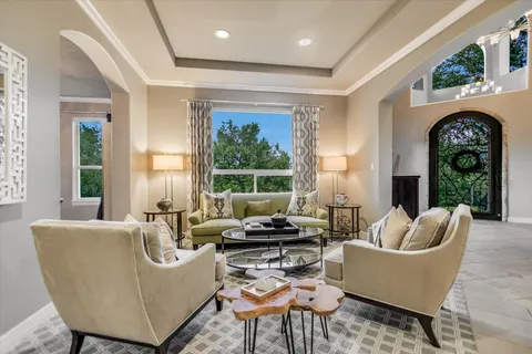 a living room with furniture a rug and a large window
