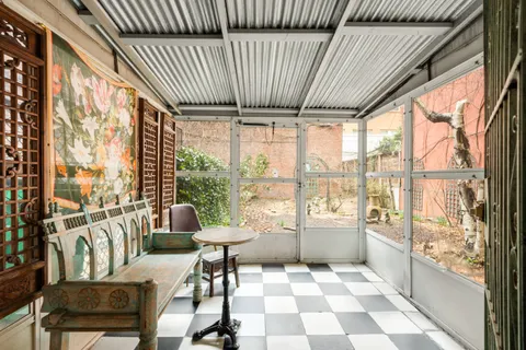a living room with furniture and a floor to ceiling window