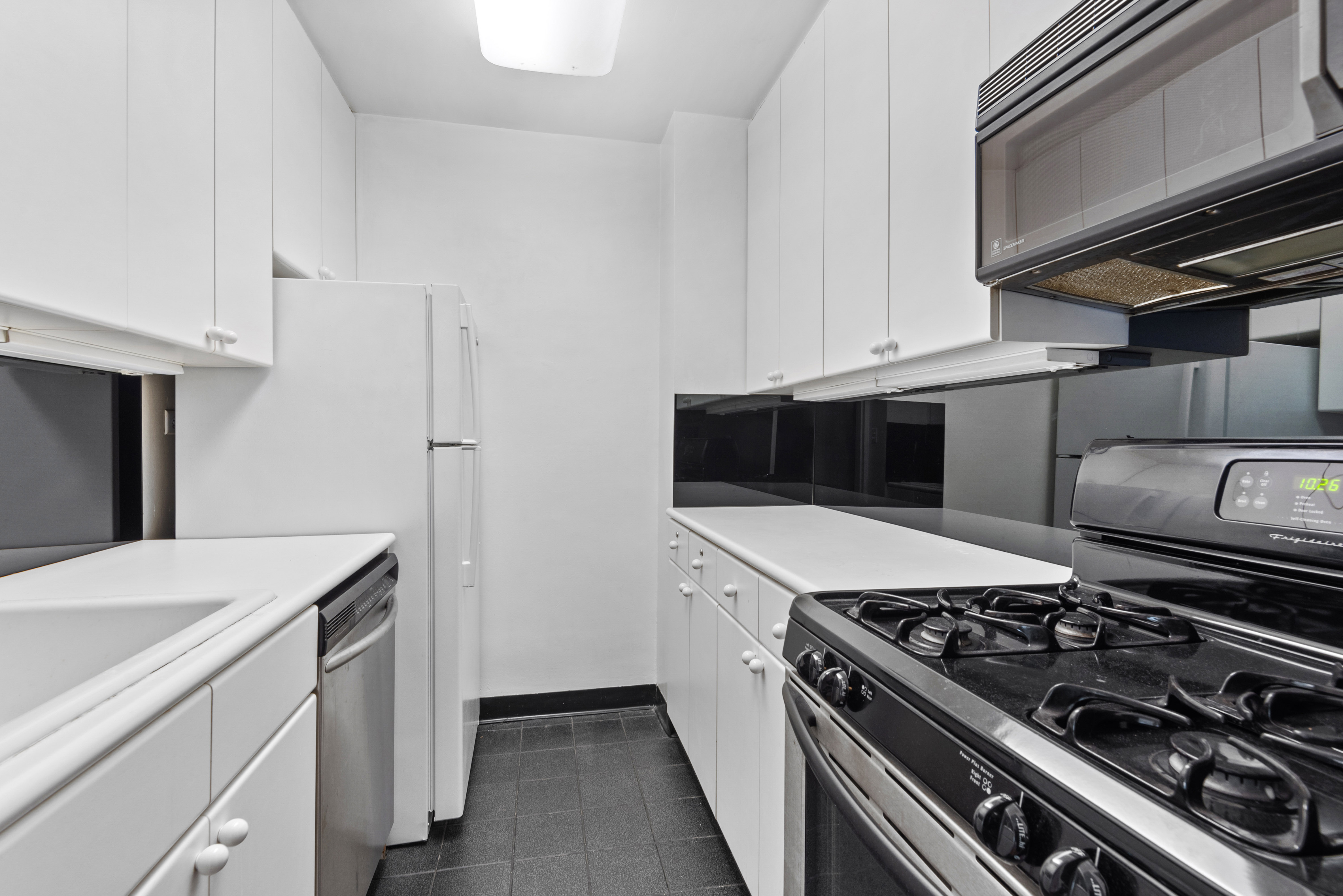 101 West 12th Street, Unit 6MN Manhattan, NY 10011 - Photo 3 of 17 a kitchen with a stove and a microwave
