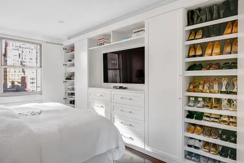 a bedroom with a bed and a book shelf