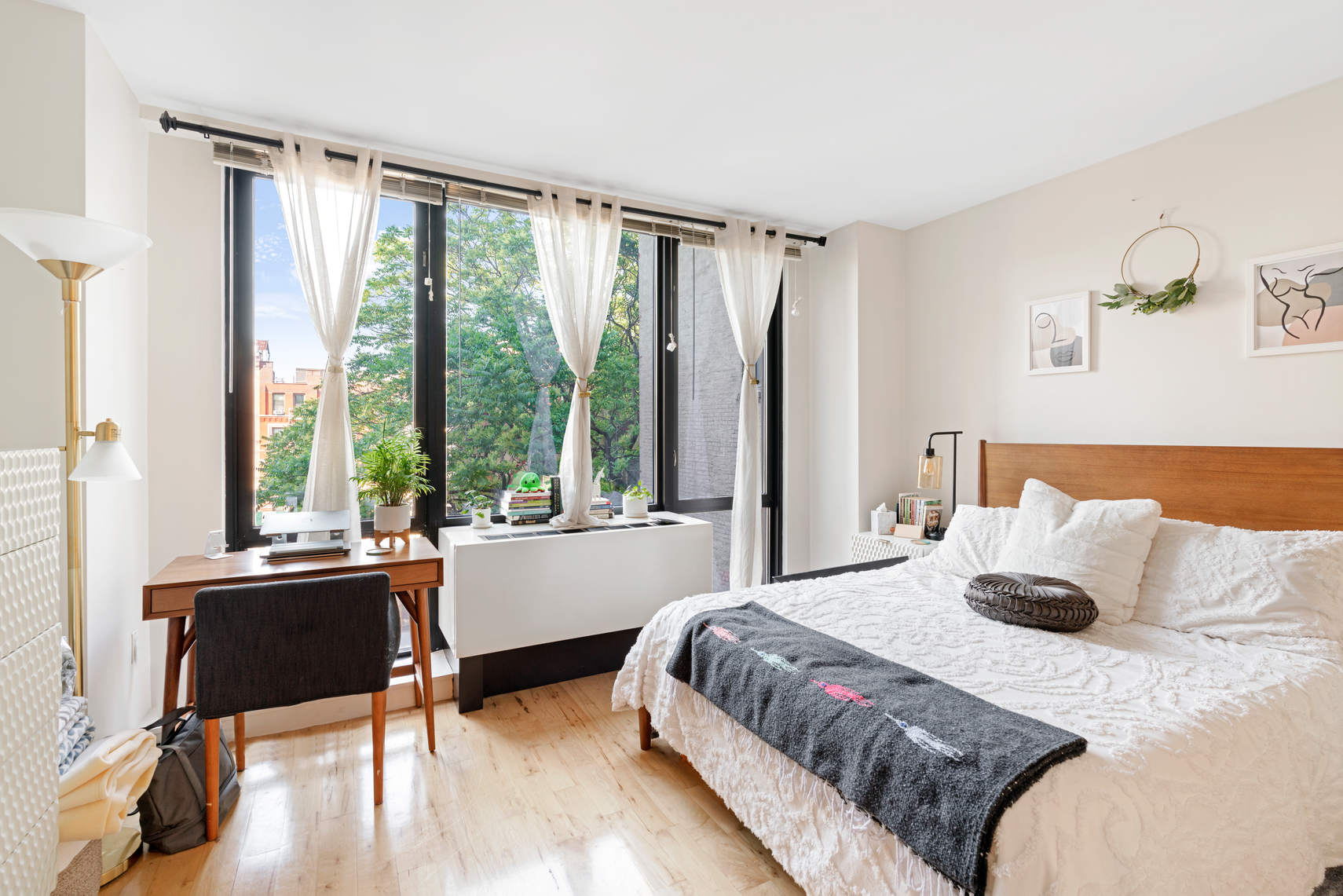 1595 Lexington Avenue, Unit 4H Manhattan, NY 10029 - Photo 4 of 9 a bedroom with a bed and a large window