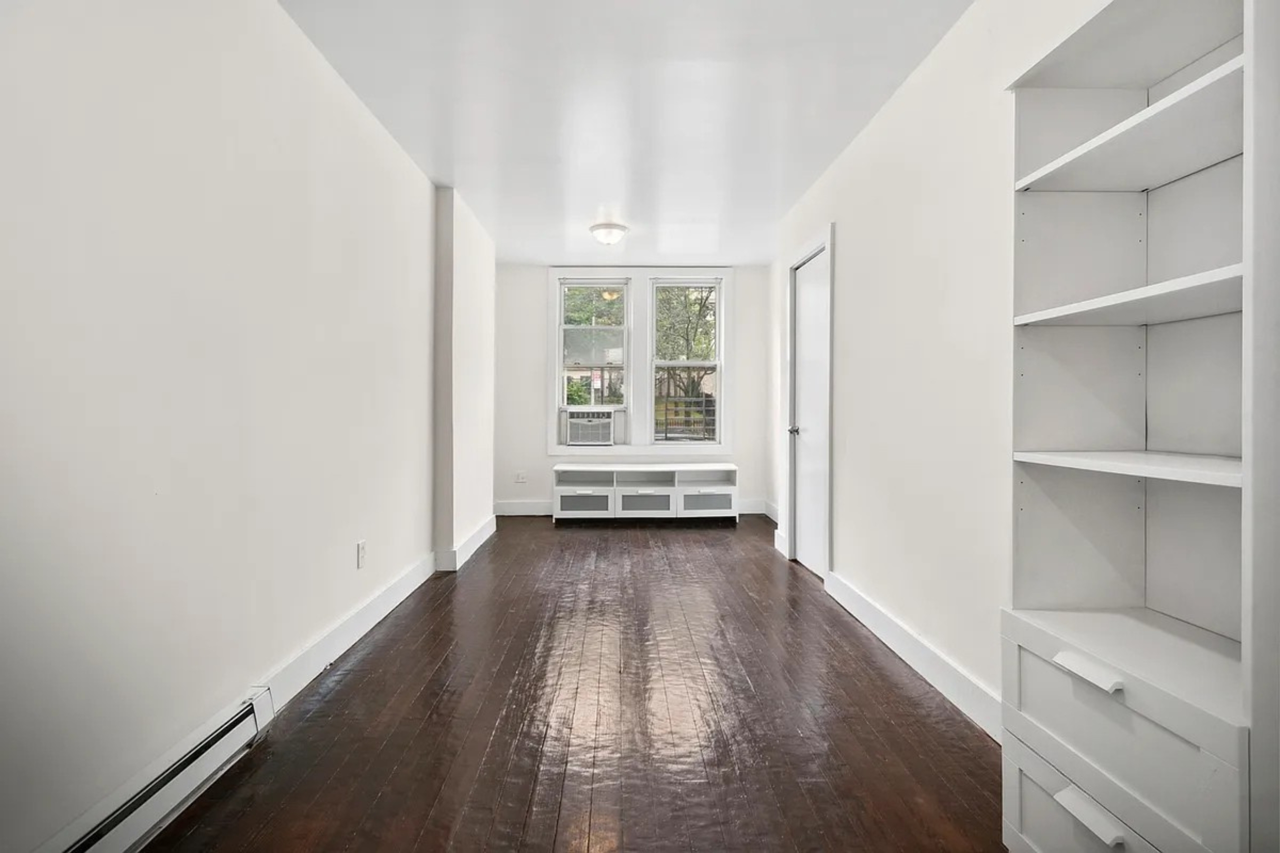 22-42 41st Street, Unit 2R Queens, NY 11105 - Photo 5 of 10 a view of a room with wooden floor and windows