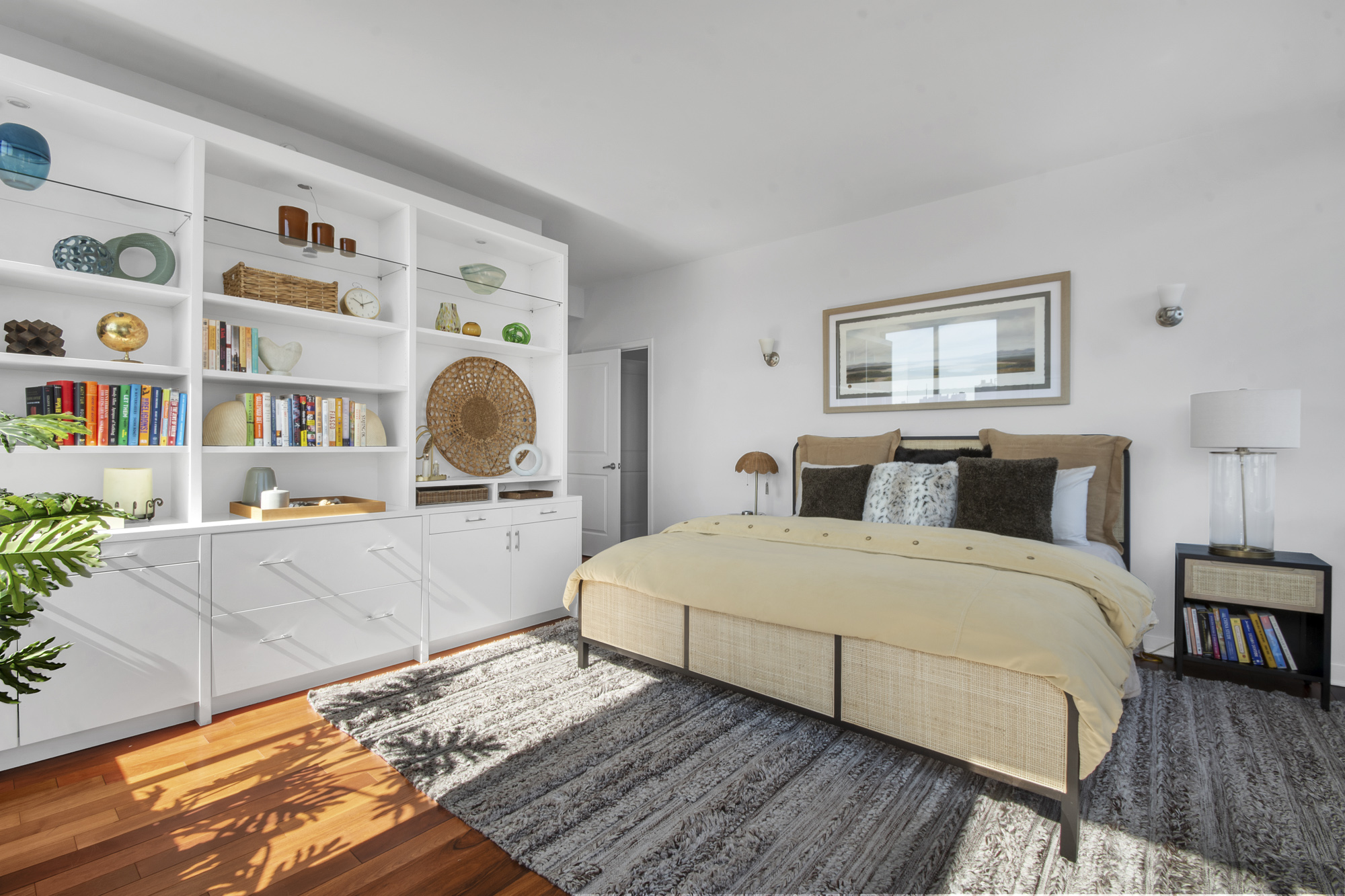 301 West 118th Street, Unit PH1F Manhattan, NY 10026 - Photo 9 of 15 a bedroom with a bed lamp and book shelf
