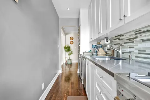 a kitchen with stainless steel appliances granite countertop a sink and a stove