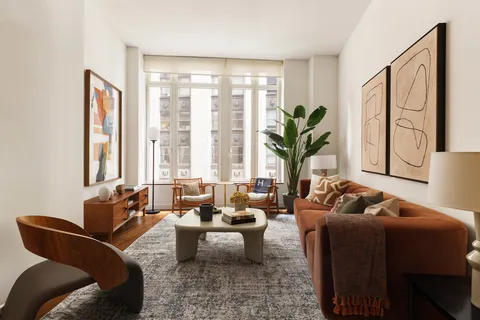 a living room with furniture and floor to windows