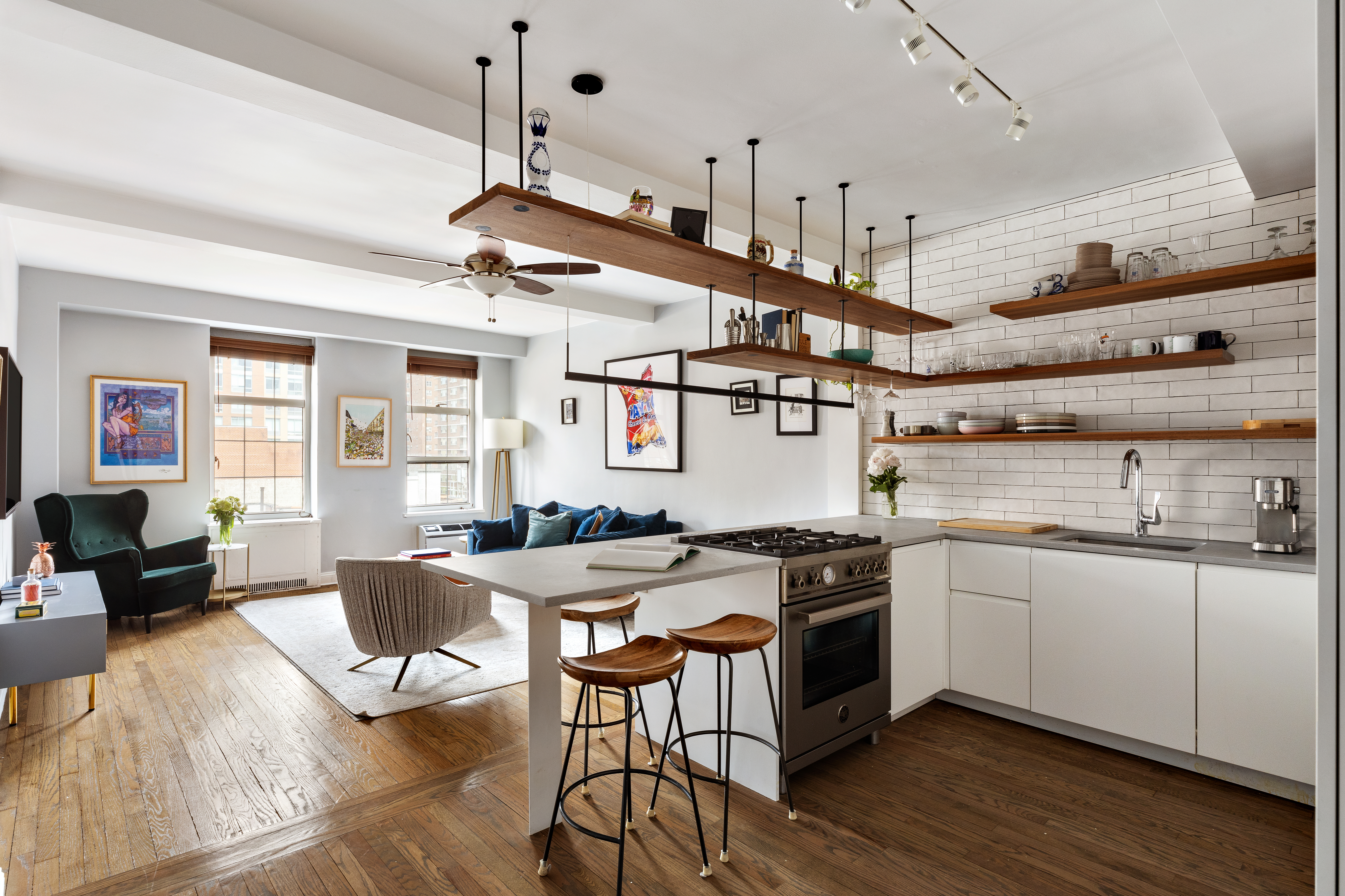 410 West 24th Street, Unit 9K Manhattan, NY 10011 - Photo 3 of 10 a kitchen with stainless steel appliances granite countertop a sink a stove and a wooden floors