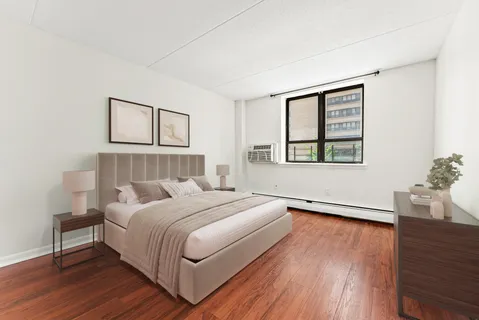 a bedroom with a bed and wooden floor