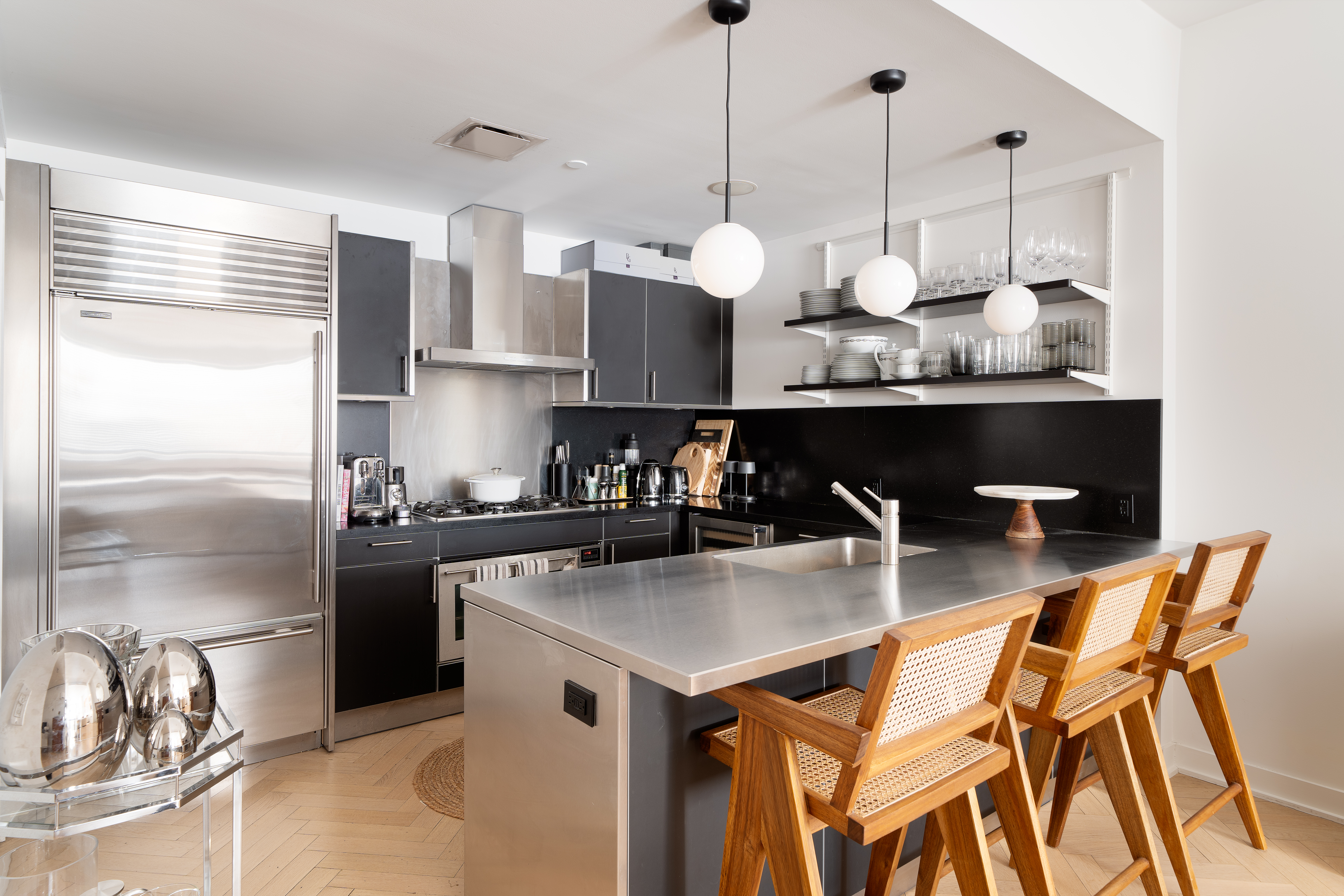 330 Spring Street, Unit 5C Manhattan, NY 10013 - Photo 4 of 18 a kitchen with stainless steel appliances granite countertop a stove a sink and a refrigerator