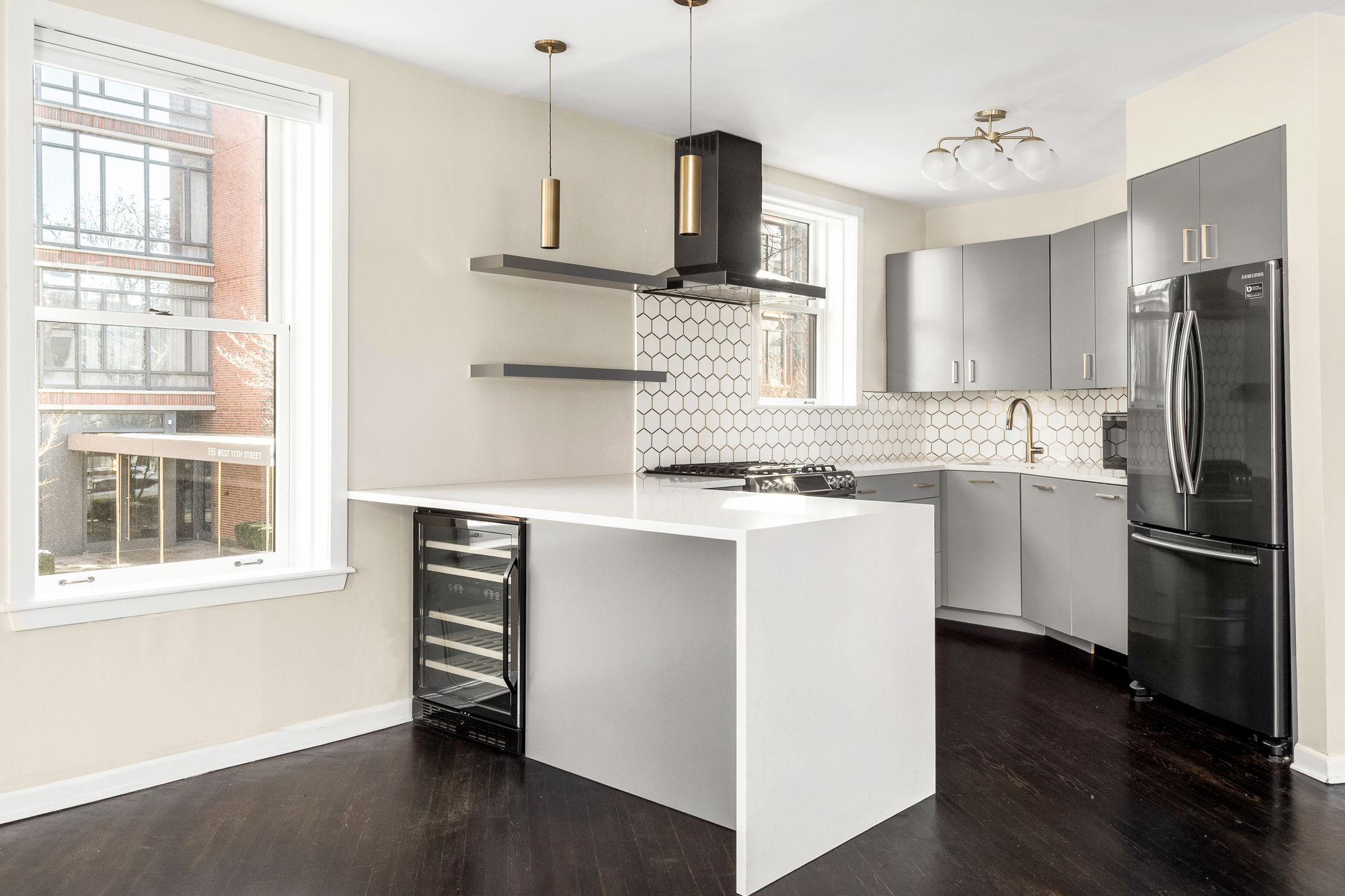 160 West 11th Street, Unit 1 Manhattan, NY 10011 - Photo 7 of 18 a kitchen with stainless steel appliances cabinets a sink and a window