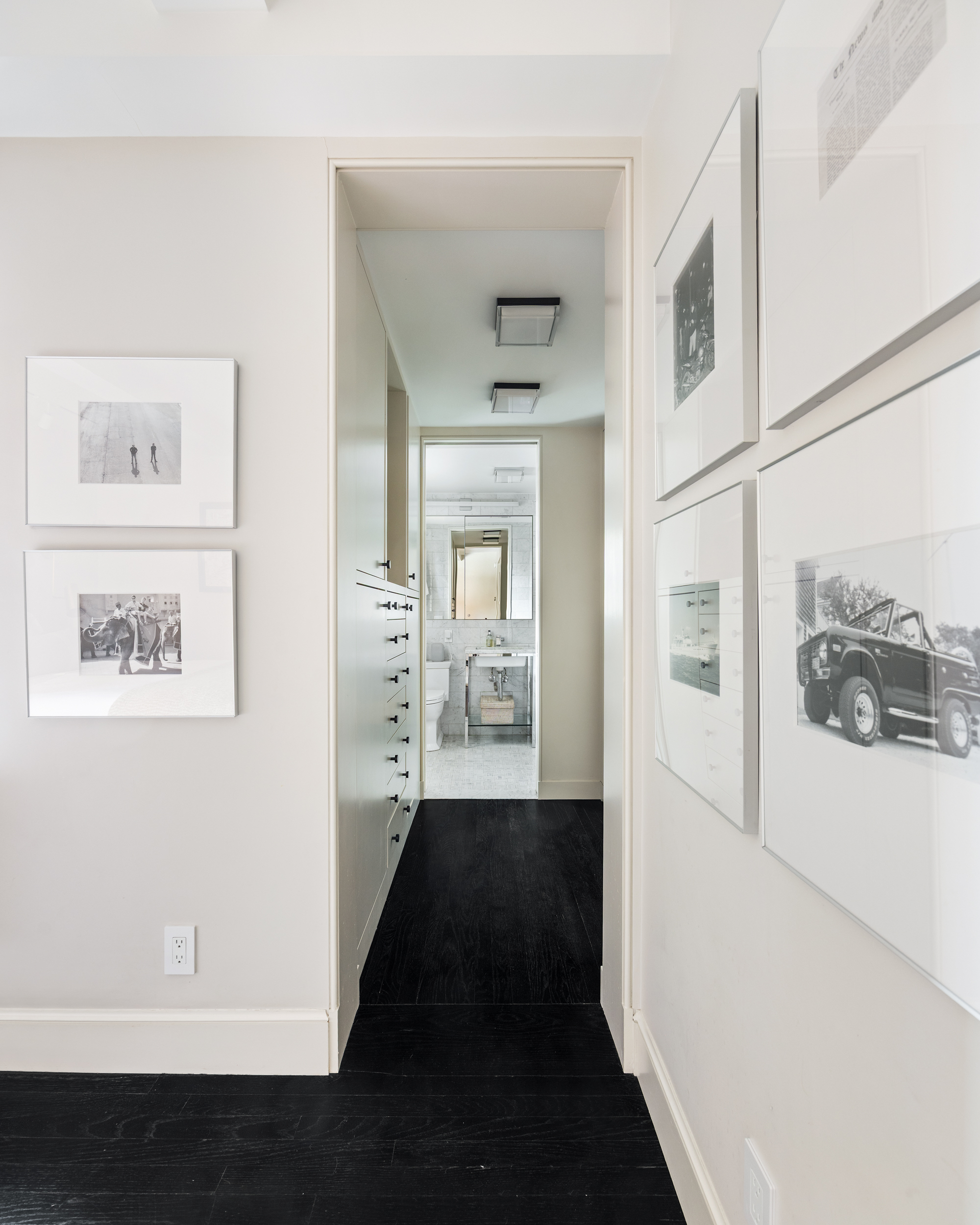 169 East 78th Street, Unit 7C Manhattan, NY 10075 - Photo 21 of 30 a view of a hallway with paintings on the wall