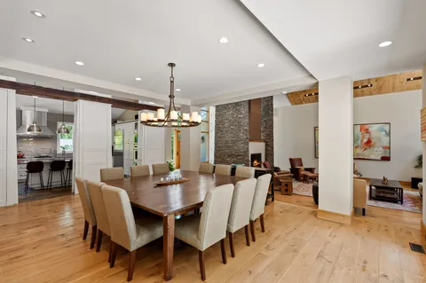 a kitchen with stainless steel appliances kitchen island granite countertop a stove and white cabinets