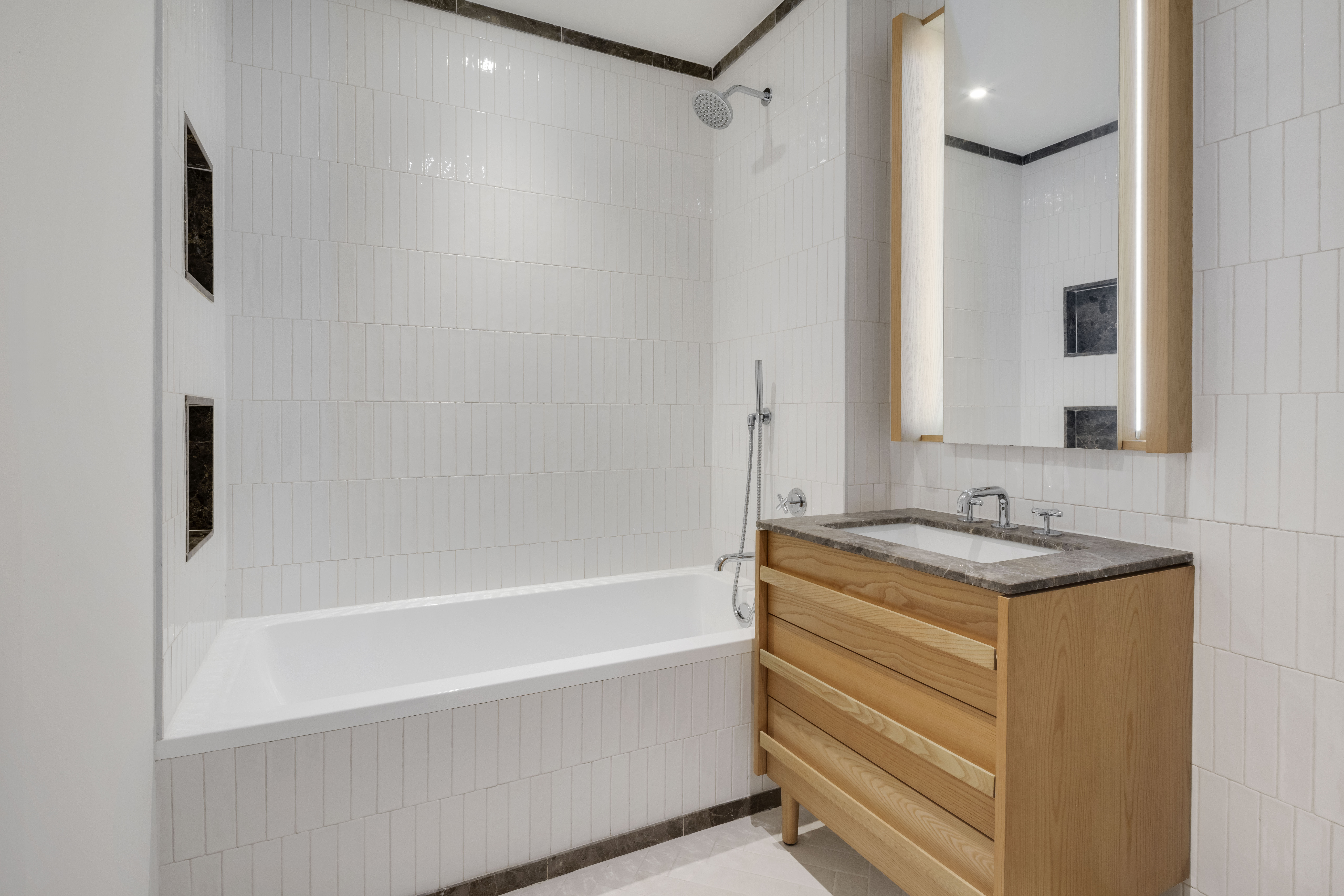 22-18 Jackson Avenue, Unit 719 Queens, NY 11101 - Photo 7 of 12 a bath room with a sink and a mirror