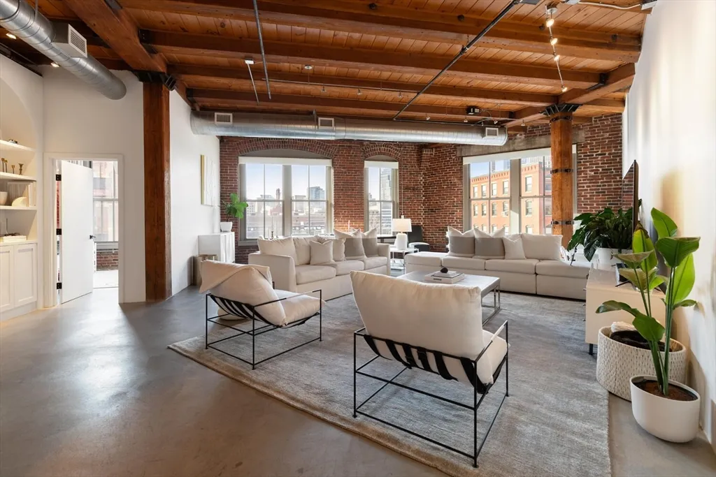 a living room with furniture and a potted plant