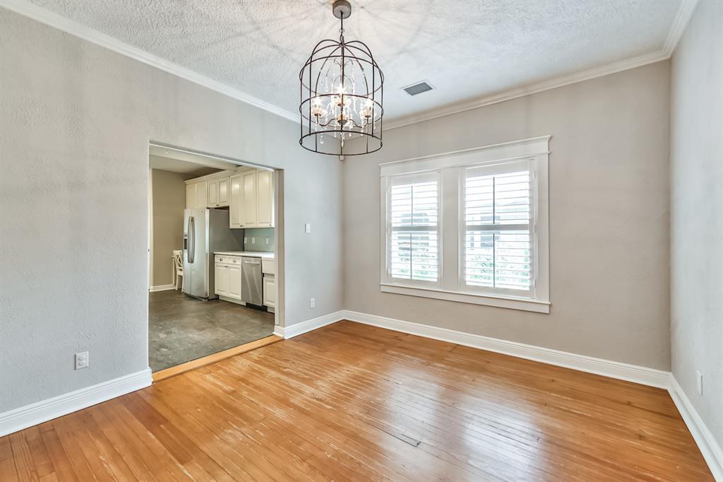 1120 Winston Street Houston, TX 77009 - Photo 10 of 29 a view of empty room with wooden floor and windows
