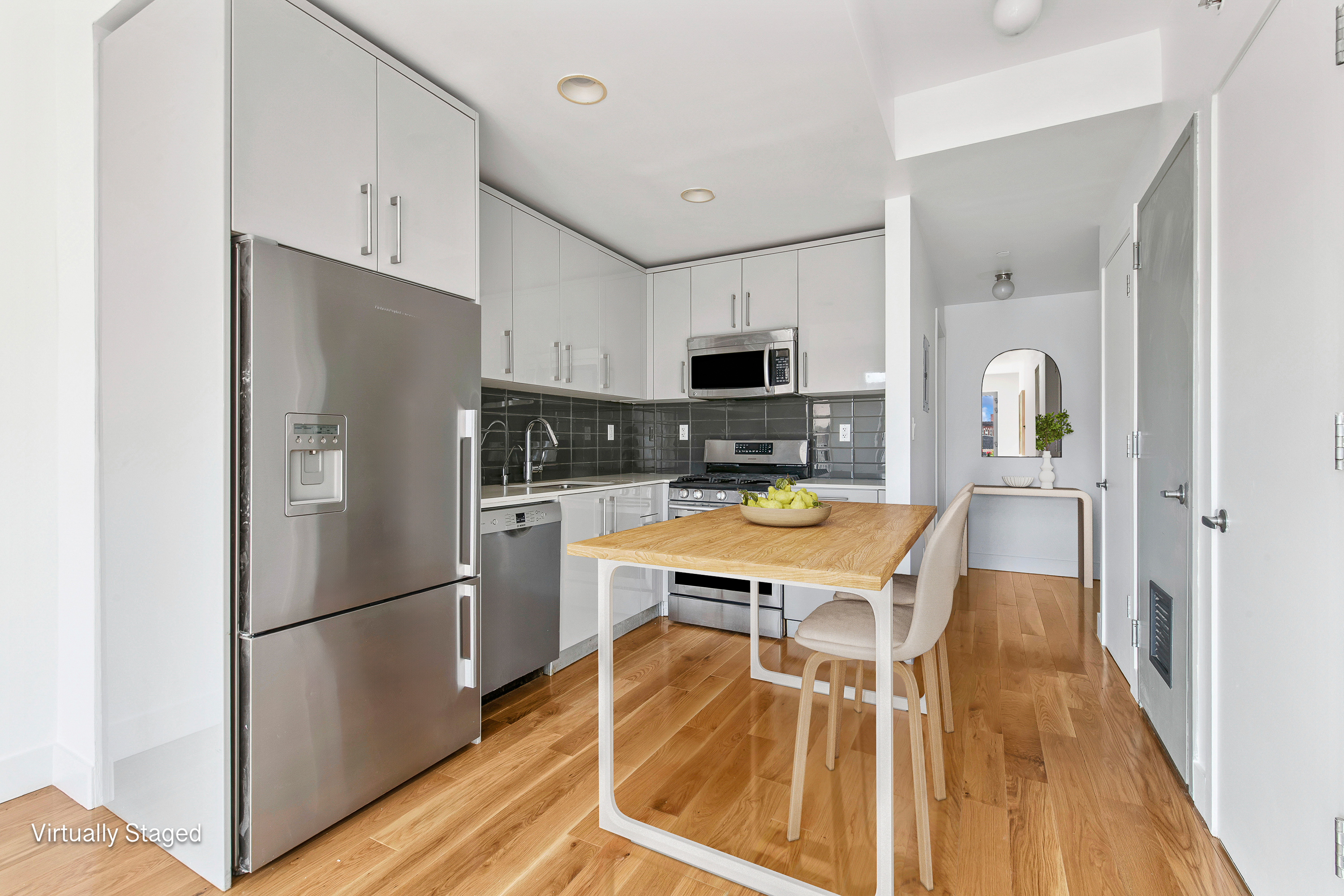 139 Skillman Avenue, Unit 4B Brooklyn, NY 11211 - Photo 5 of 19 a kitchen with stainless steel appliances a refrigerator stove microwave and cabinets
