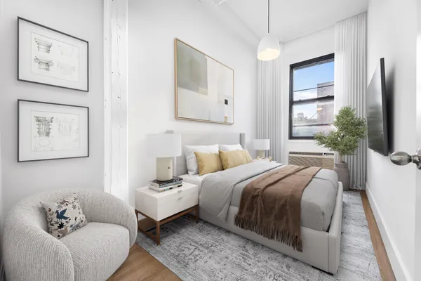 a bedroom with a bed and a couch