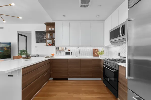a kitchen with stainless steel appliances a sink stove and refrigerator