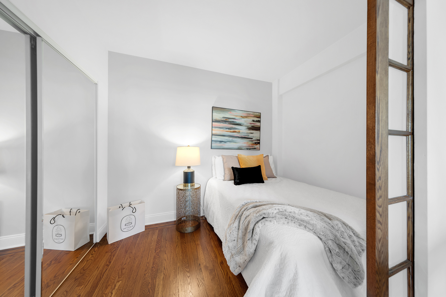 200 West 20th Street, Unit 1110 Manhattan, NY 10011 - Photo 5 of 10 a bedroom with a bed and wooden floor
