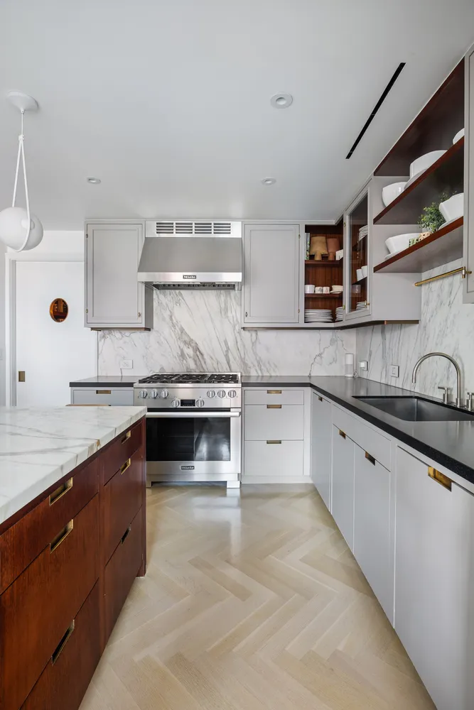a large kitchen with stainless steel appliances granite countertop a stove and a sink