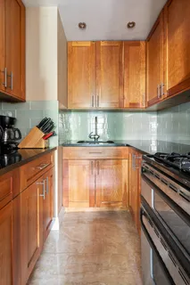 a kitchen with stainless steel appliances granite countertop a sink stove and cabinets