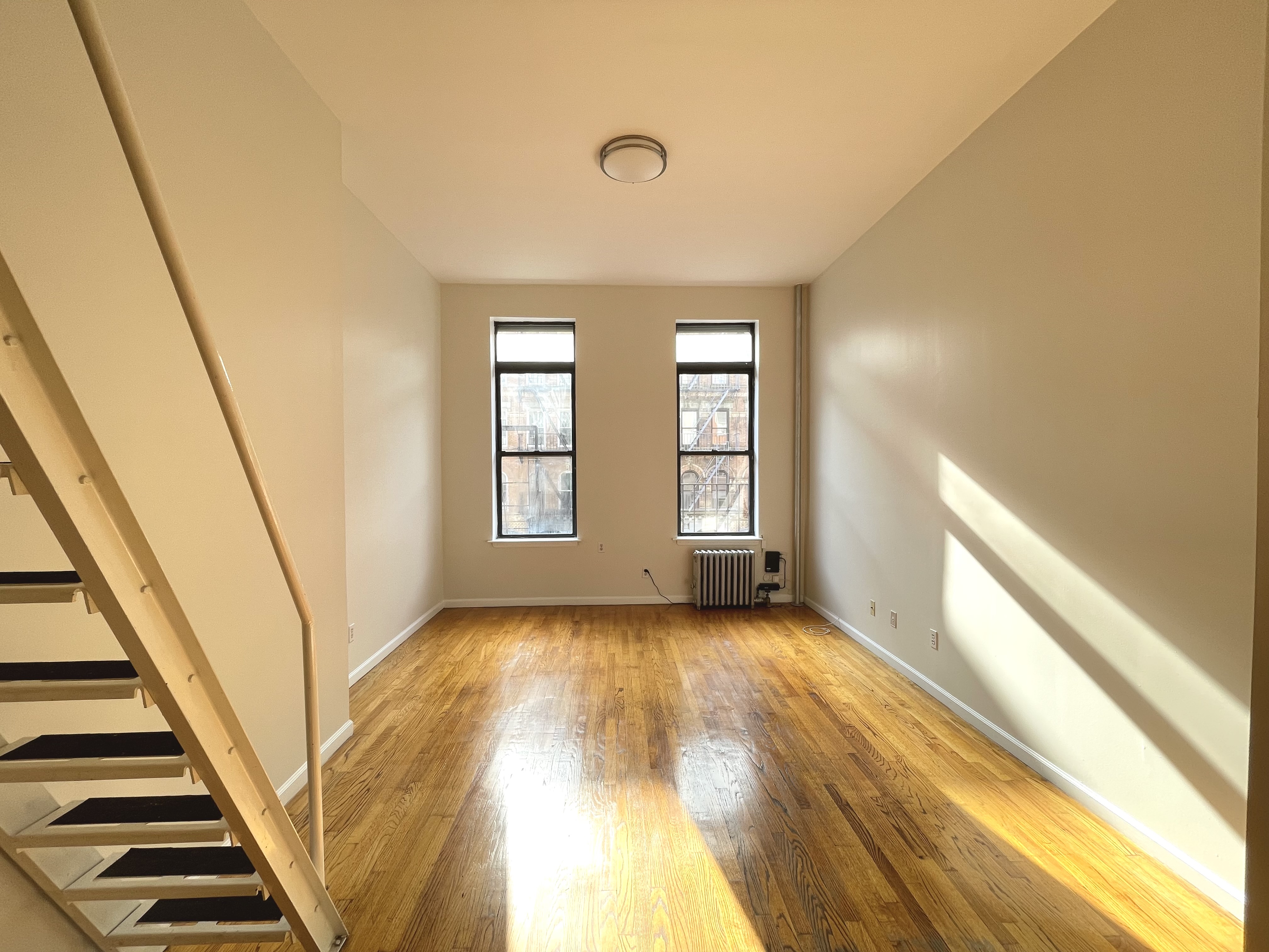 95 St Marks Place, Unit 6 Manhattan, NY 10009 - Photo 7 of 14 a view of an empty room with a window
