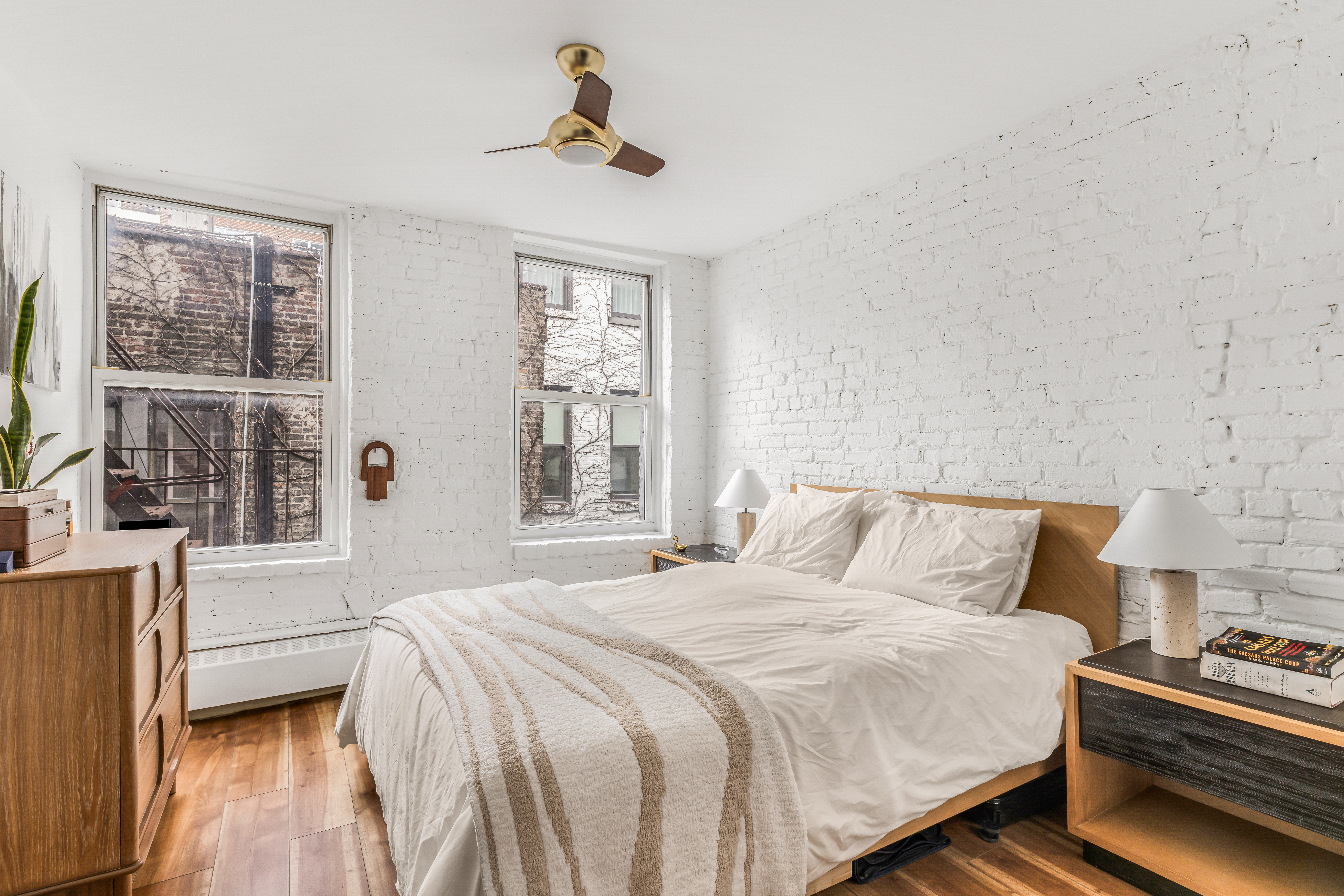 15 Jones Street, Unit 5D Manhattan, NY 10014 - Photo 4 of 7 a bedroom with a bed and a window