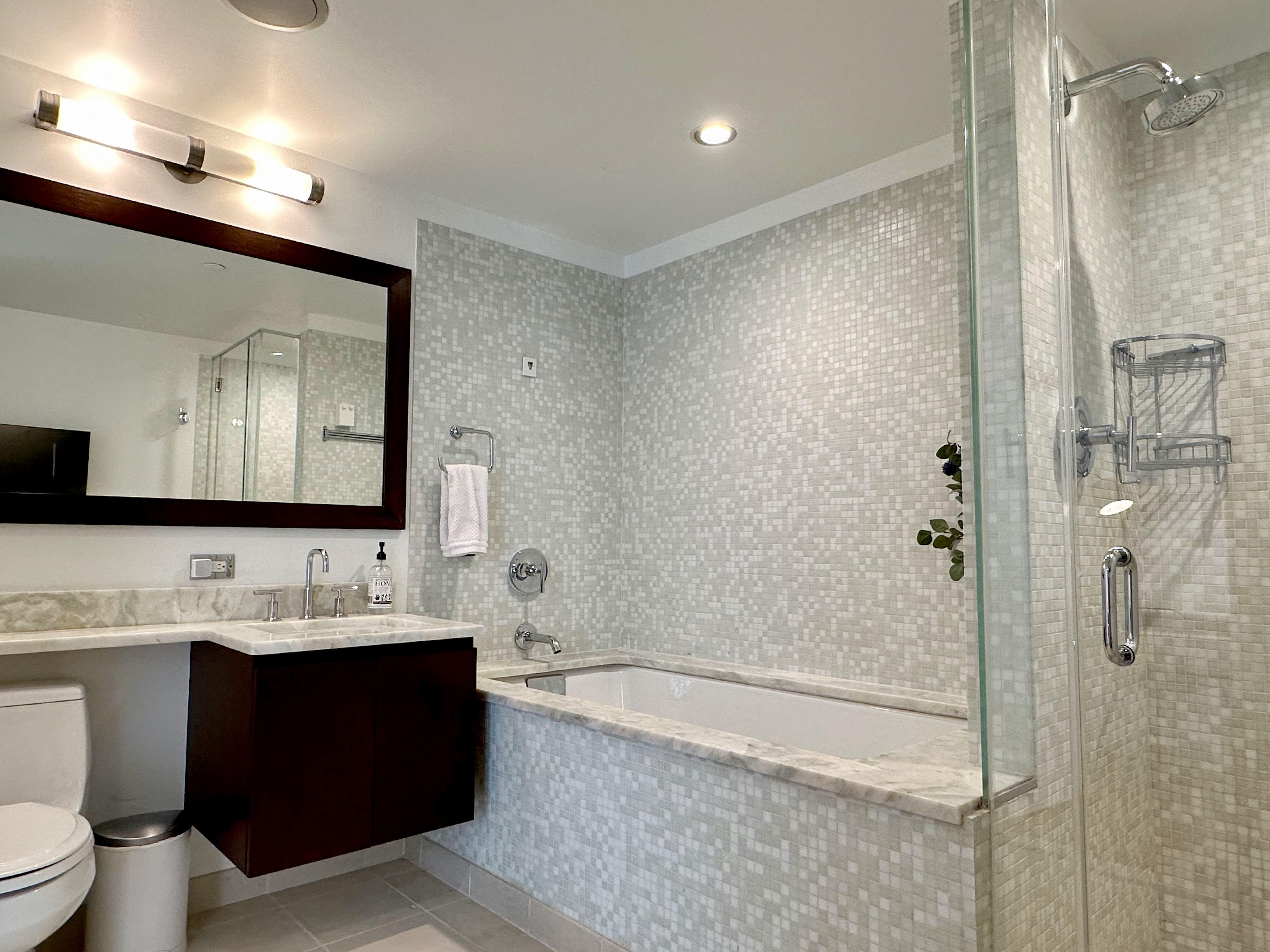 350 West 53rd Street, Unit PHA Manhattan, NY 10019 - Photo 21 of 35 a bathroom with a tub sink and mirror