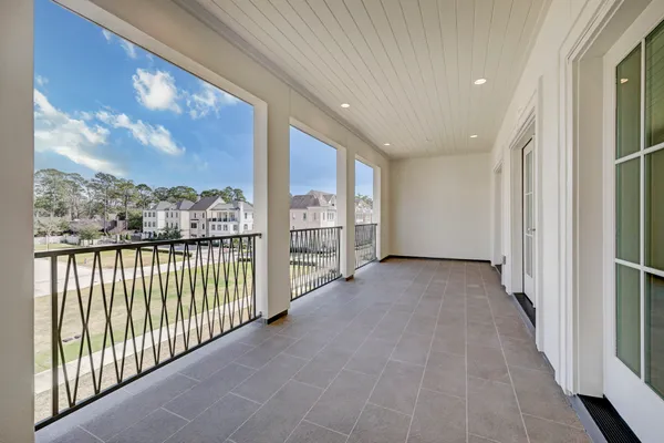 a view of a hallway with wooden floor and fence