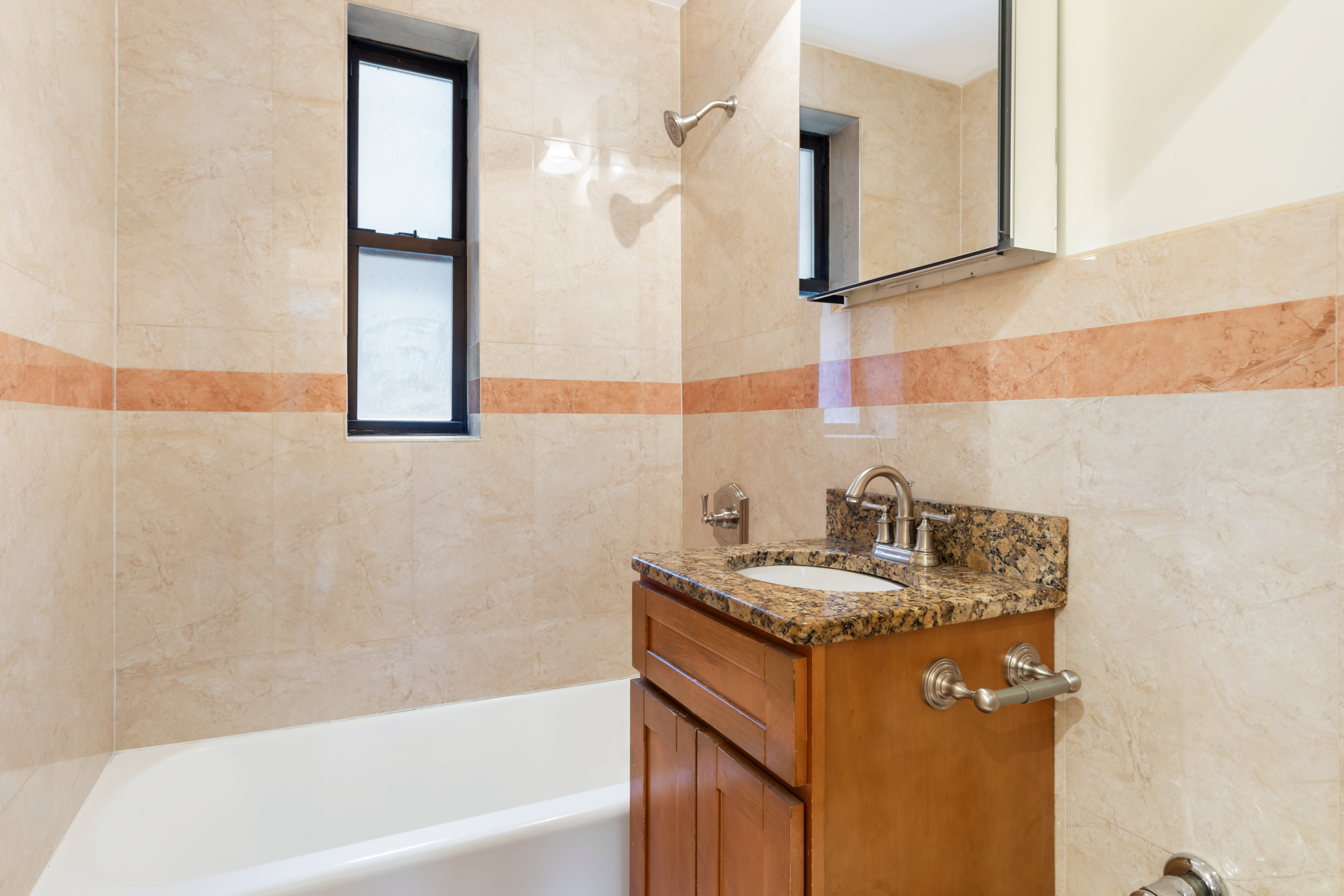145 East 22nd Street, Unit 5G Manhattan, NY 10010 - Photo 4 of 5 a bathroom with a granite countertop sink and a mirror