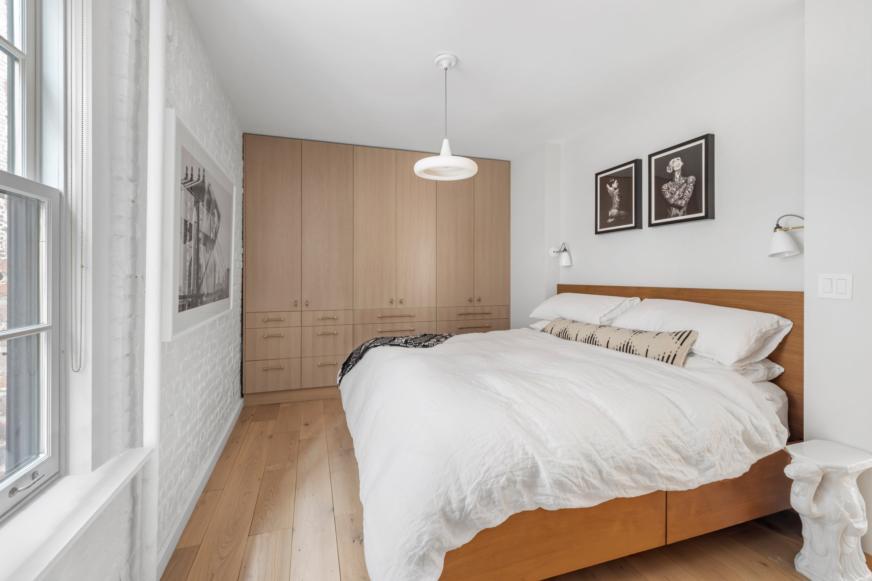 57 Thompson Street, Unit 4E Manhattan, NY 10012 - Photo 11 of 16 a bedroom with a bed and a window