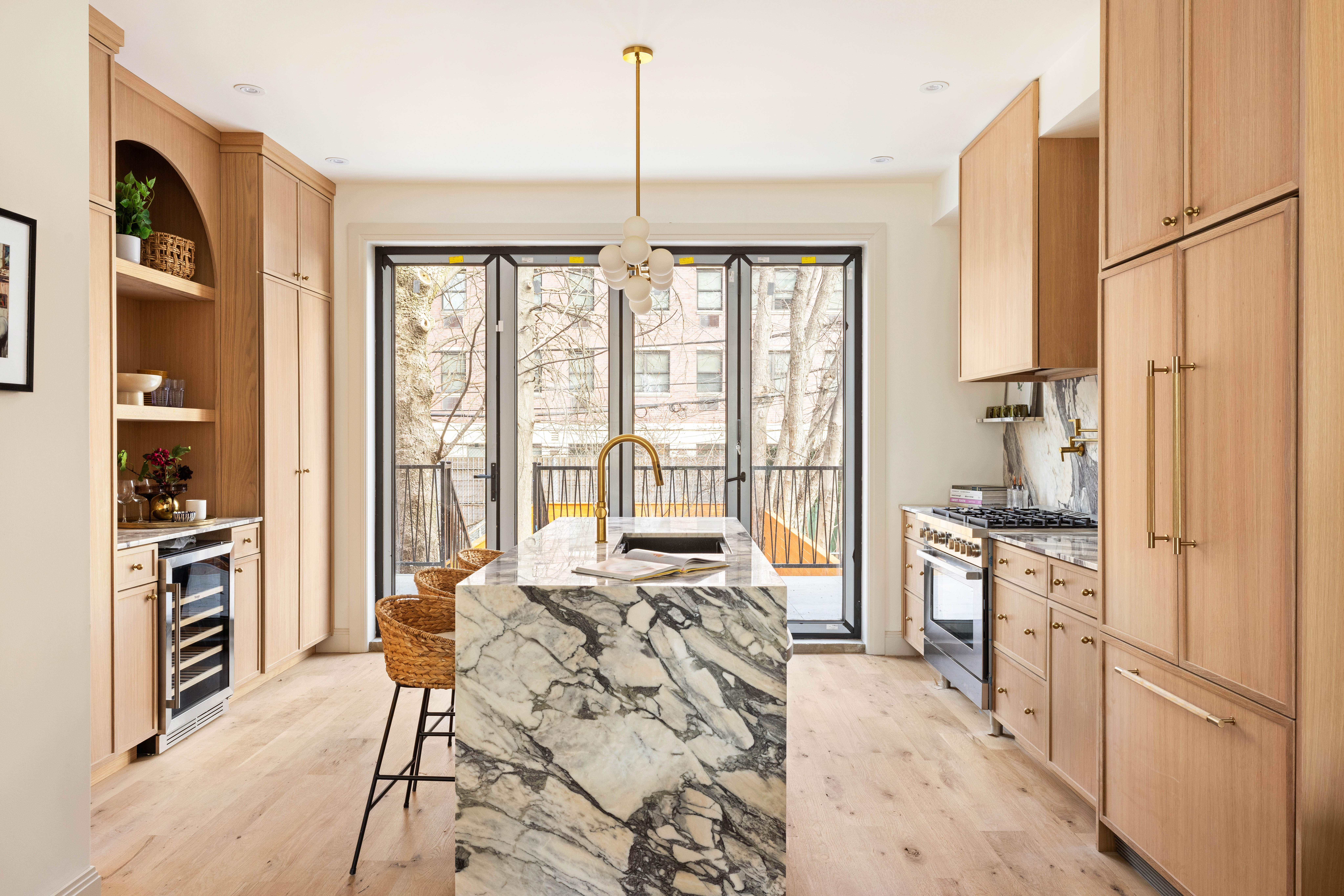 311 Monroe Street Brooklyn, NY 11216 - Photo 4 of 18 a large kitchen with a large window and stainless steel appliances