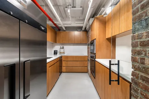 a kitchen with granite countertop a refrigerator and a stove