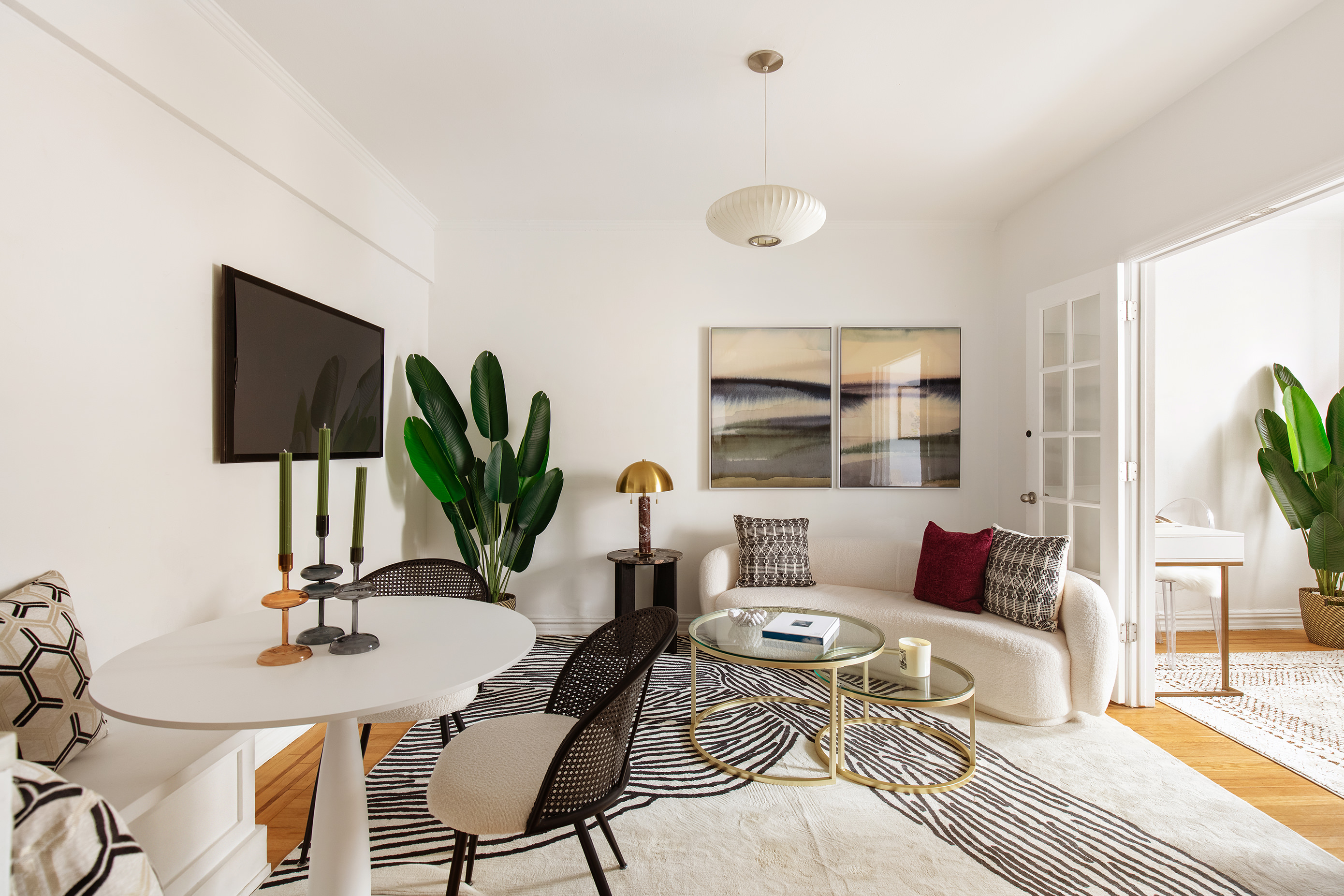 a living room with furniture fireplace and a large window