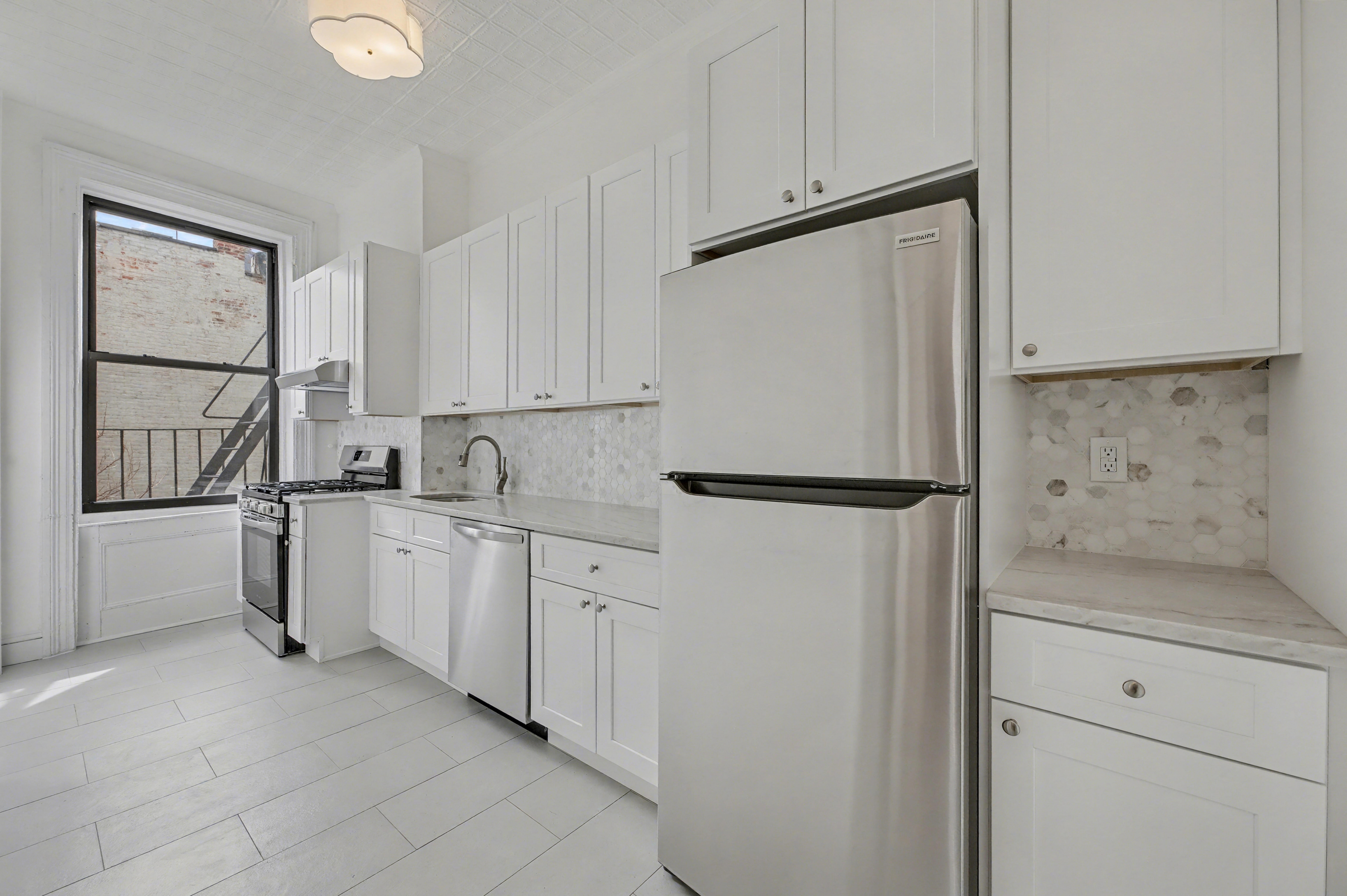 261 Clinton Street, Unit 3 Brooklyn, NY 11201 - Photo 2 of 12 a kitchen with white cabinets and white appliances